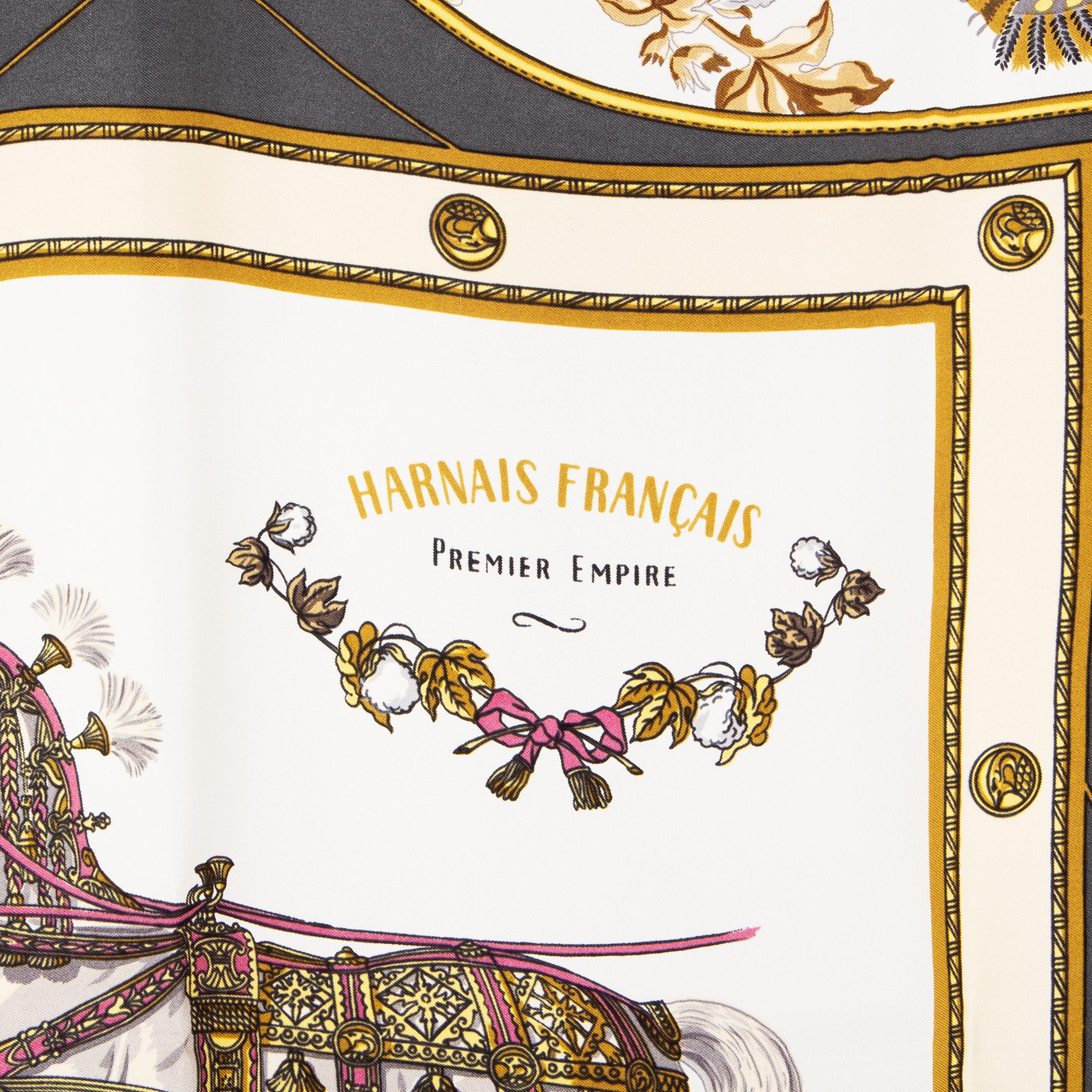 Hermes 'Harnais Francais Premier Empire 90' scarf in white silk twill (100%) with dark grey border and details in antique gold, beige and pink. Has been carried and is in excellent condition.

Width 90cm (35.1in)
Height 90cm (35.1in)