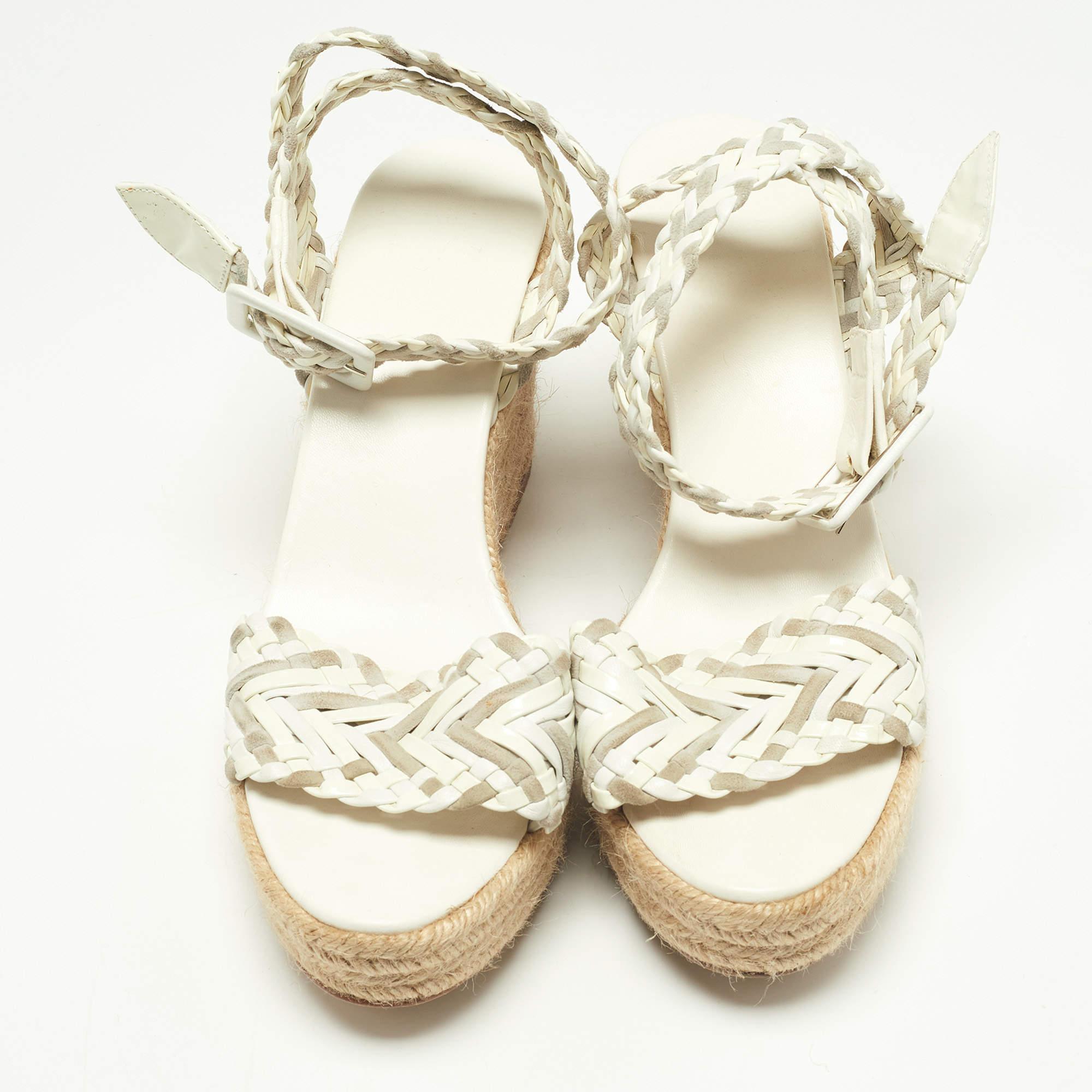 These Sofia sandals are by the house of Hermes. Made of patent leather and suede, they feature woven straps, buckle closure at the ankles, and simple espadrille wedge heels for a comfortable lift.

