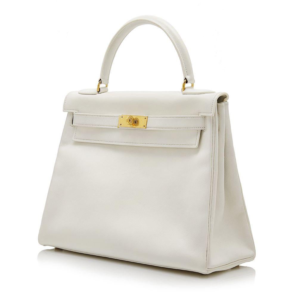 Crafted in France from smooth white gulliver leather, a fine-grained Hermès skin, notorious for its soft-to-the-touch texture and noticeably luminous finish, this vintage, Kelly Retourne bag is a true testament to the quality of the house's