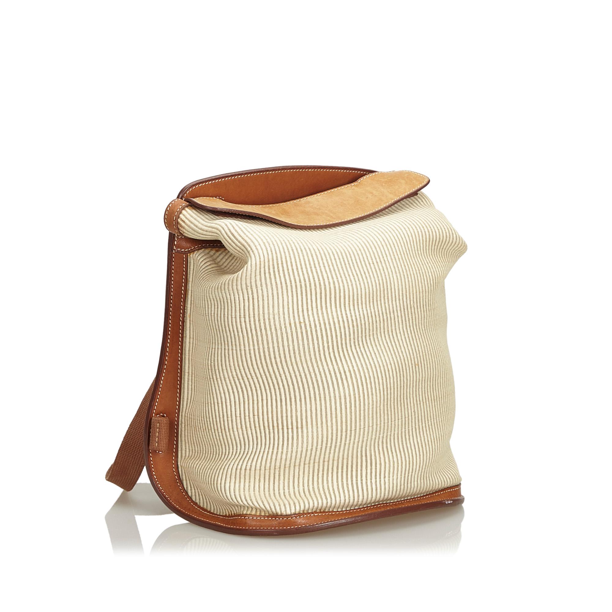 The Sherpa backpack features a canvas body with leather trim, flat back straps, a top leather flap, and an interior slip pocket. It carries as B+ condition rating.

Inclusions: 
This item does not come with inclusions.

Dimensions:
Length: 32.00