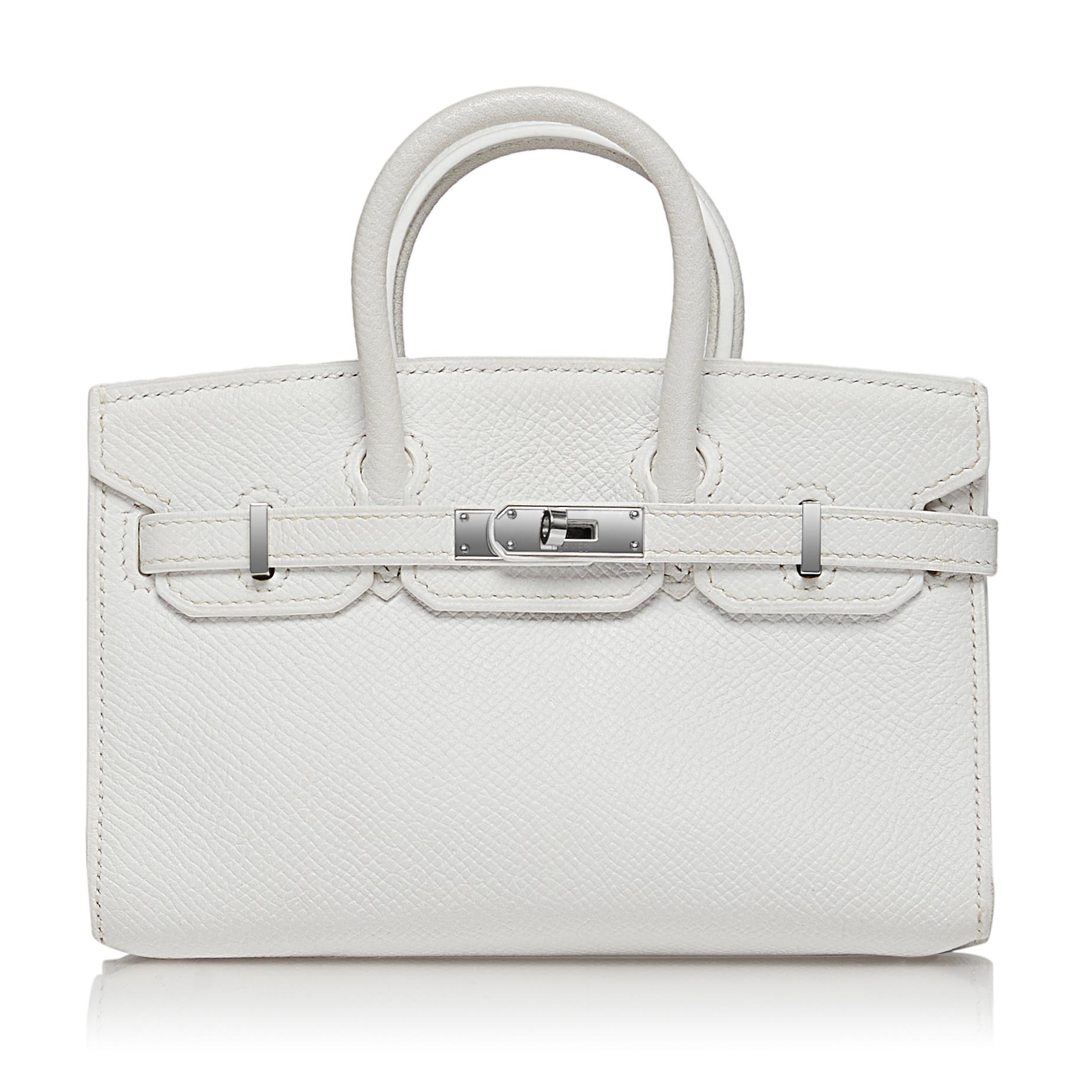Released on the last runway of Jean Paul Gaultier for Hermes in 2011, this extremely rare Hermès White Micro Birkin Handbag comes with a strap and can be worn as a wristlet, small clutch or shoulder bag. This mini Birkin might be very small but its