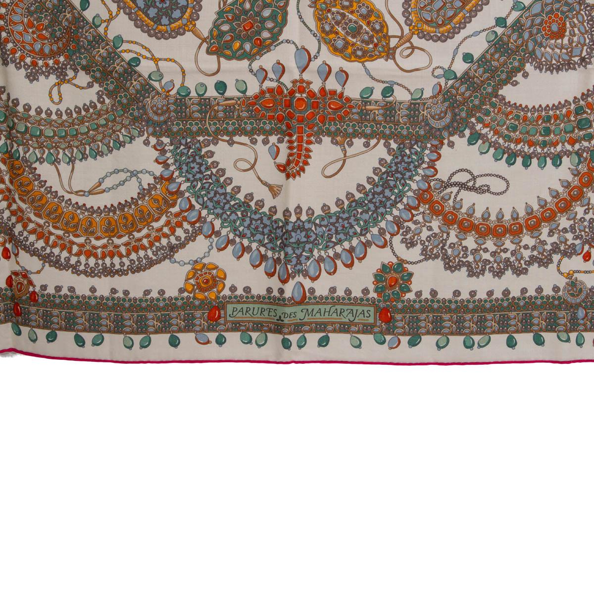 100% authentic Hermes 'Parures des Maharajas 140' shawl by Catherine Baschet in off-white cashmere (65%) and silk (35%) with pink hem and details in coral, orange, various shades of green and light blue. Has been worn and is in excellent