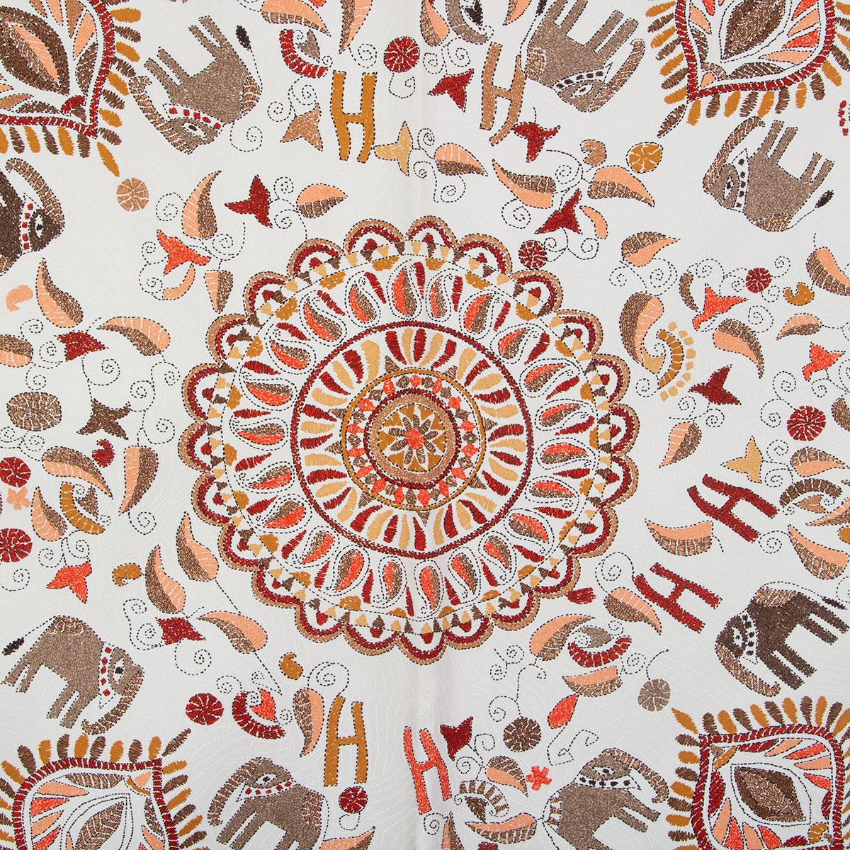 100% authentic Hermes 'Kantha 90' scarf in white silk twill (100%) with contrasting bright red hem and details in taupe, beige, salmon, ochre. Has been worn and is in excellent condition.

Designed in 2008. Inspired by traditional Indian patterns. A