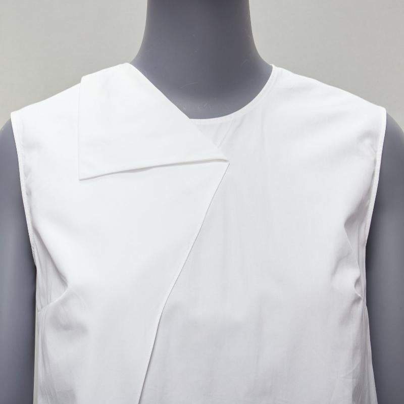 HERMES white round tromp loeil foldover collar panelled sleeveless shirt FR34 XS
Reference: SNKO/A00222
Brand: Hermes
Material: Cotton
Color: White
Pattern: Solid
Closure: Keyhole Button
Extra Details: Back yoke.
Made in: