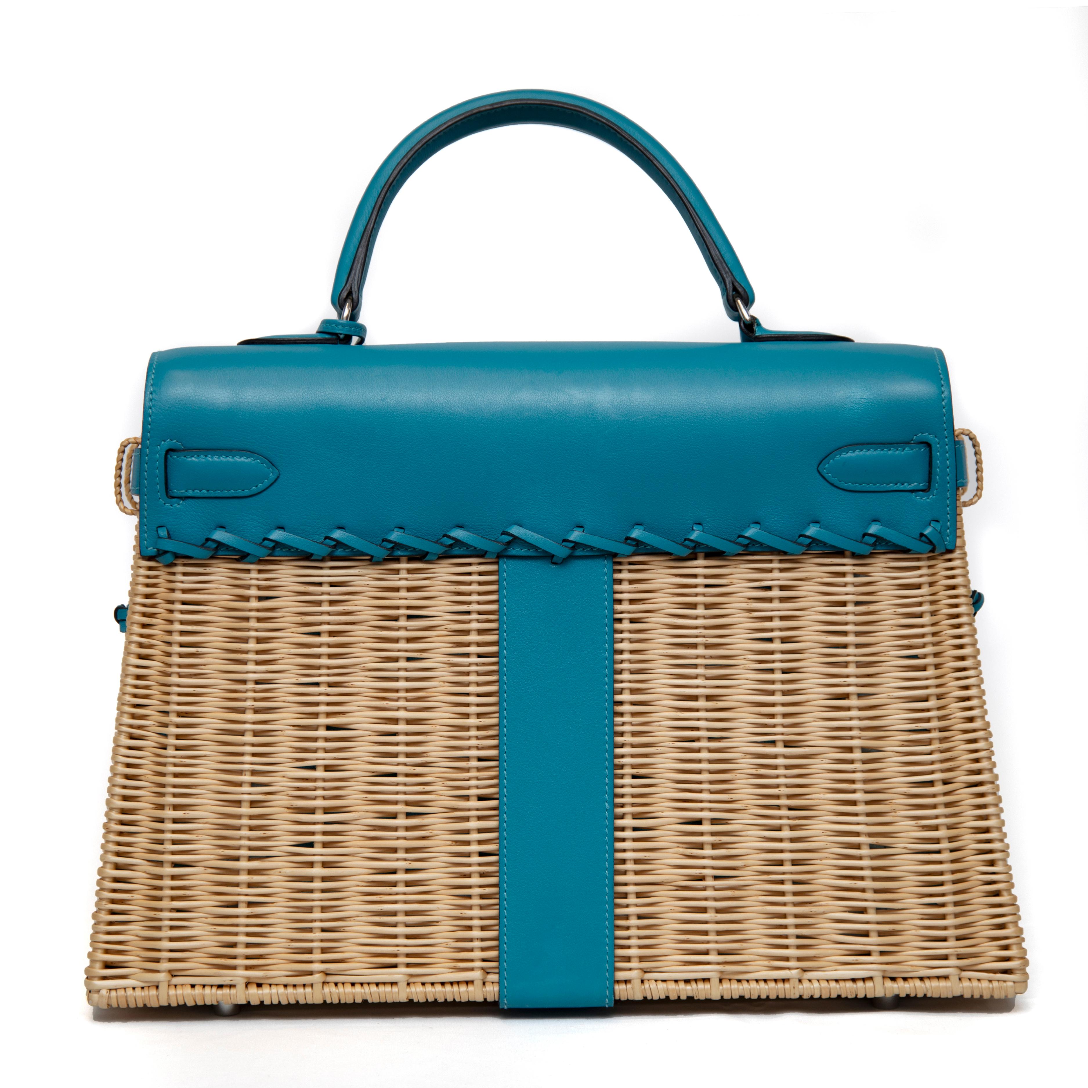 This Hermès Picnic Kelly Bag, crafted in 2013, is a rare and exquisite piece that perfectly blends luxury with rustic charm. Made from Osier wicker, the body of the bag is complemented by a front flap of rich turquoise Swift leather, creating a