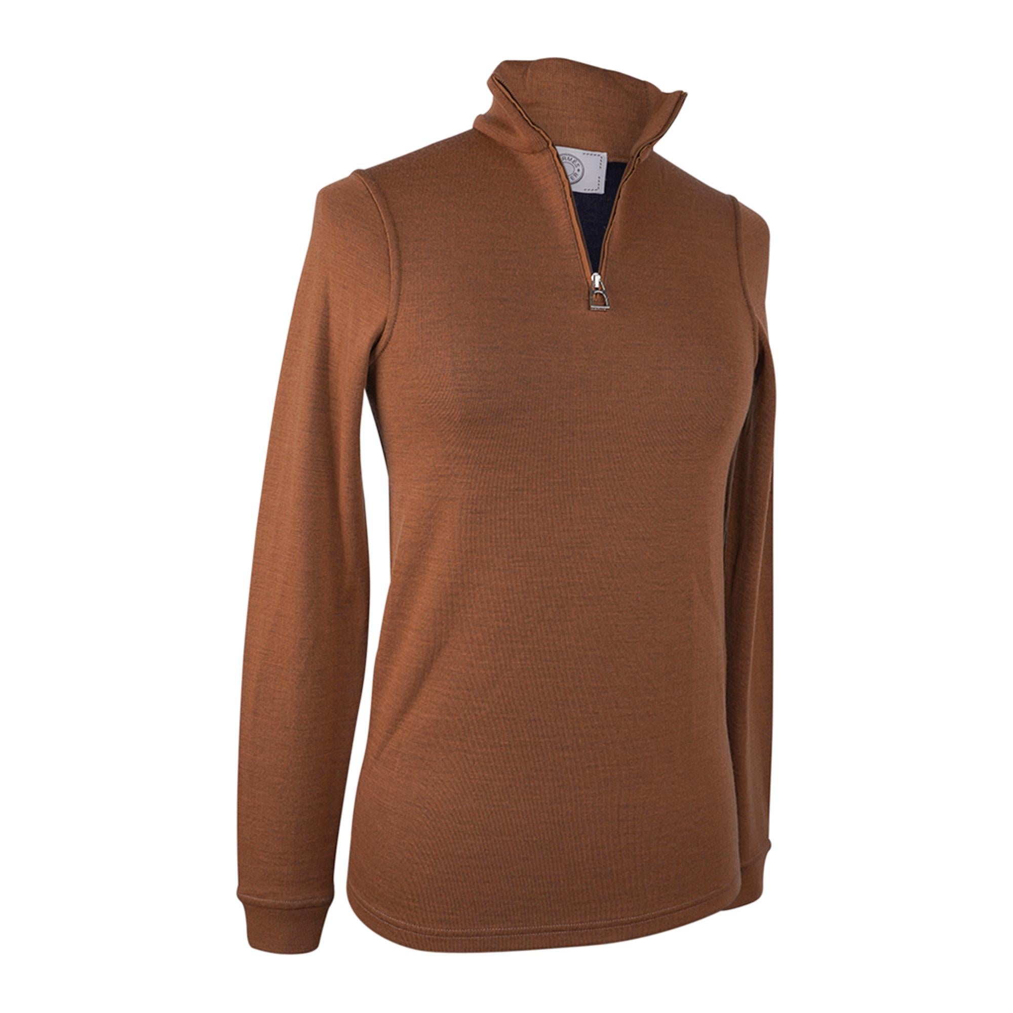 Mightychic offers an Hermes Women's Cocoon Base Layer Top in Fauve.
Long sleeved extra thin Merino wool blend top.
Part of the Equestrian collection, the cut and fabric promote freedom of
movement.
Polo neck collar and zip with logo embossed stirrup