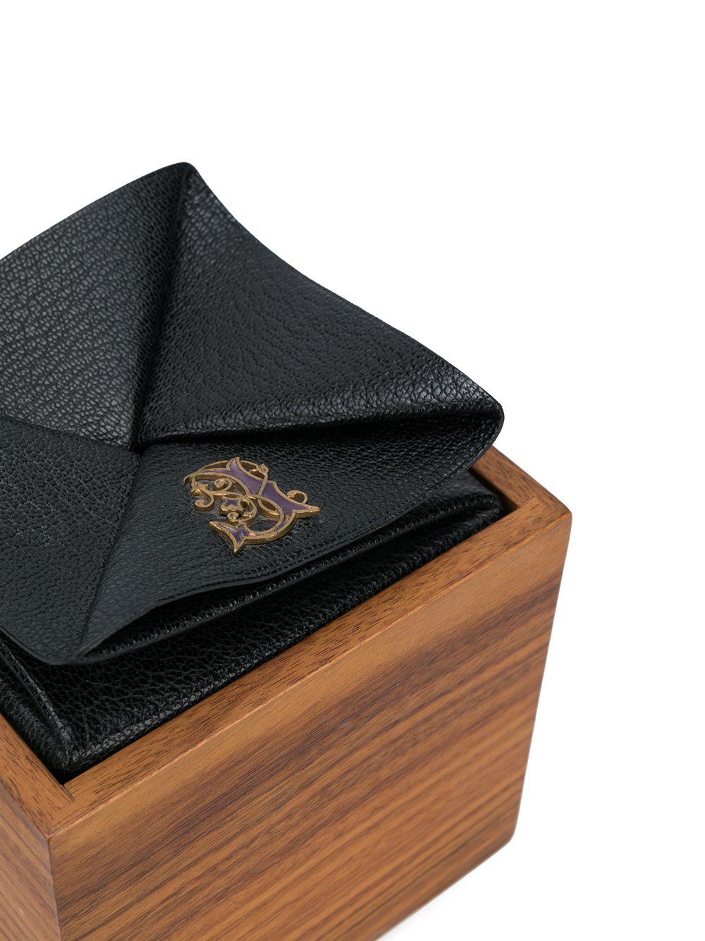 Crafted from an intricate combination of brown stained wood and raven black chevre leather, this vintage jewellery box by Hermès features a distinctive cubic box design and the iconic debossed Hermès lettering seal stamped decoratively onto the soft