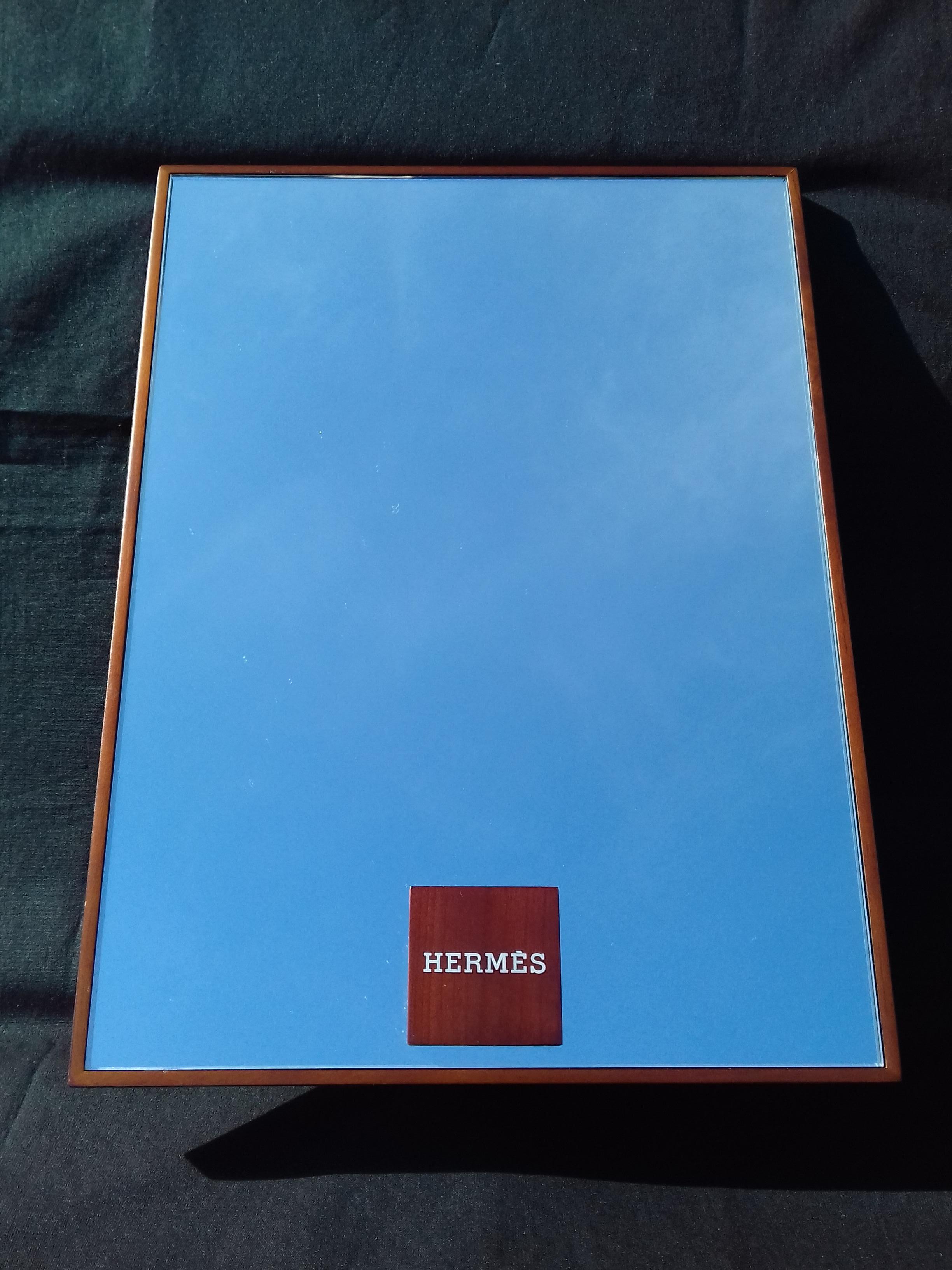 Authentic Hermès Mirror

The mirror is surrounded by a wooden frame

The base is a rectangle of wood

