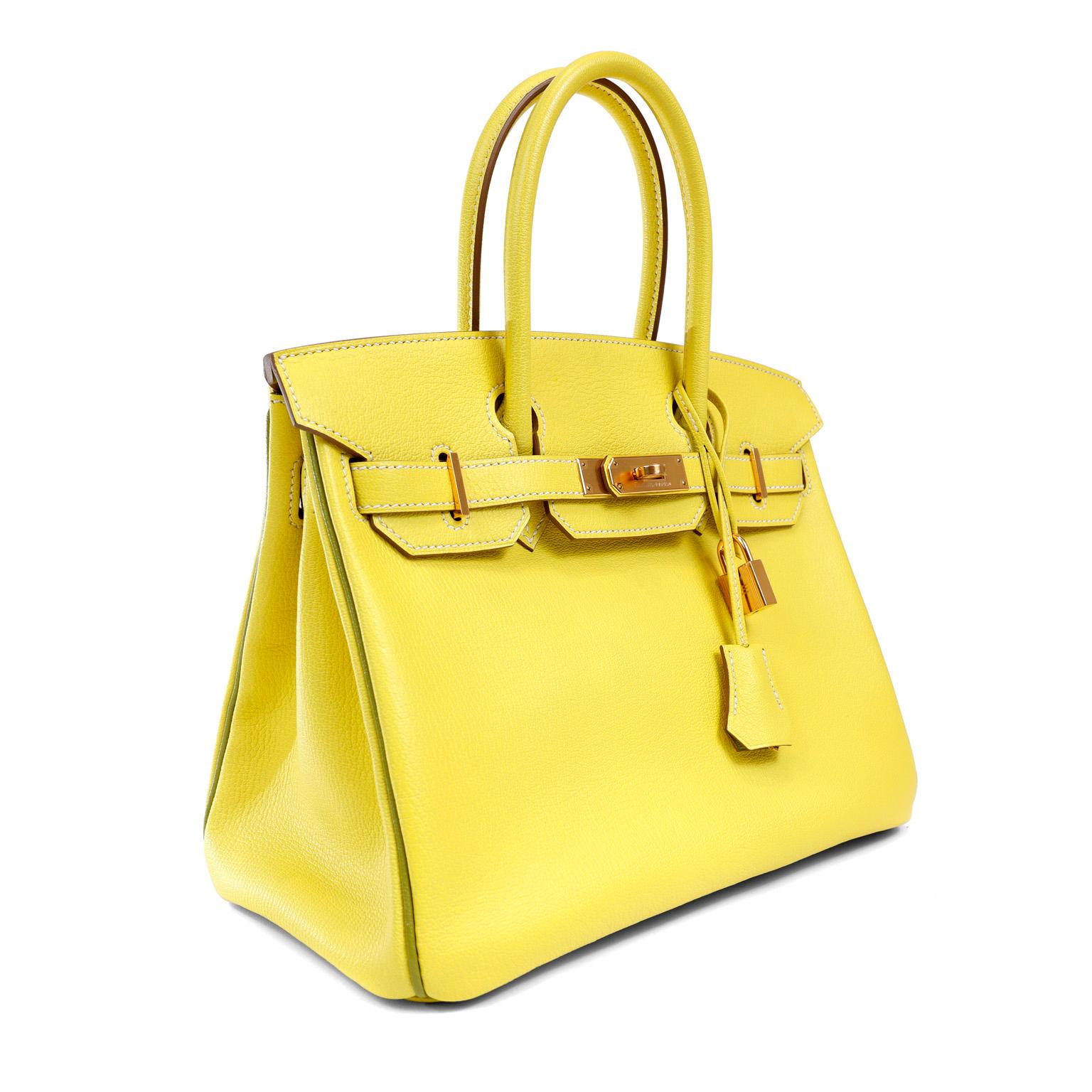 This authentic Hermès Yellow Chevre 30 cm Horseshoe Birkin is in pristine unworn condition.  The protective plastic is intact on the hardware and it is an extremely rare specially ordered piece.  Special details include Vert Anis piping, white