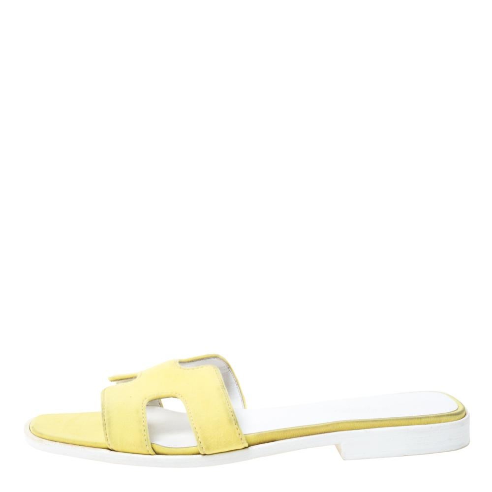 Put your best foot forward this season in these pretty Hermes sandals. These yellow Oran sandals have been crafted from fabric in Italy and they feature the iconic H on the vamps as well as insoles meant to provide comfort at every step. These