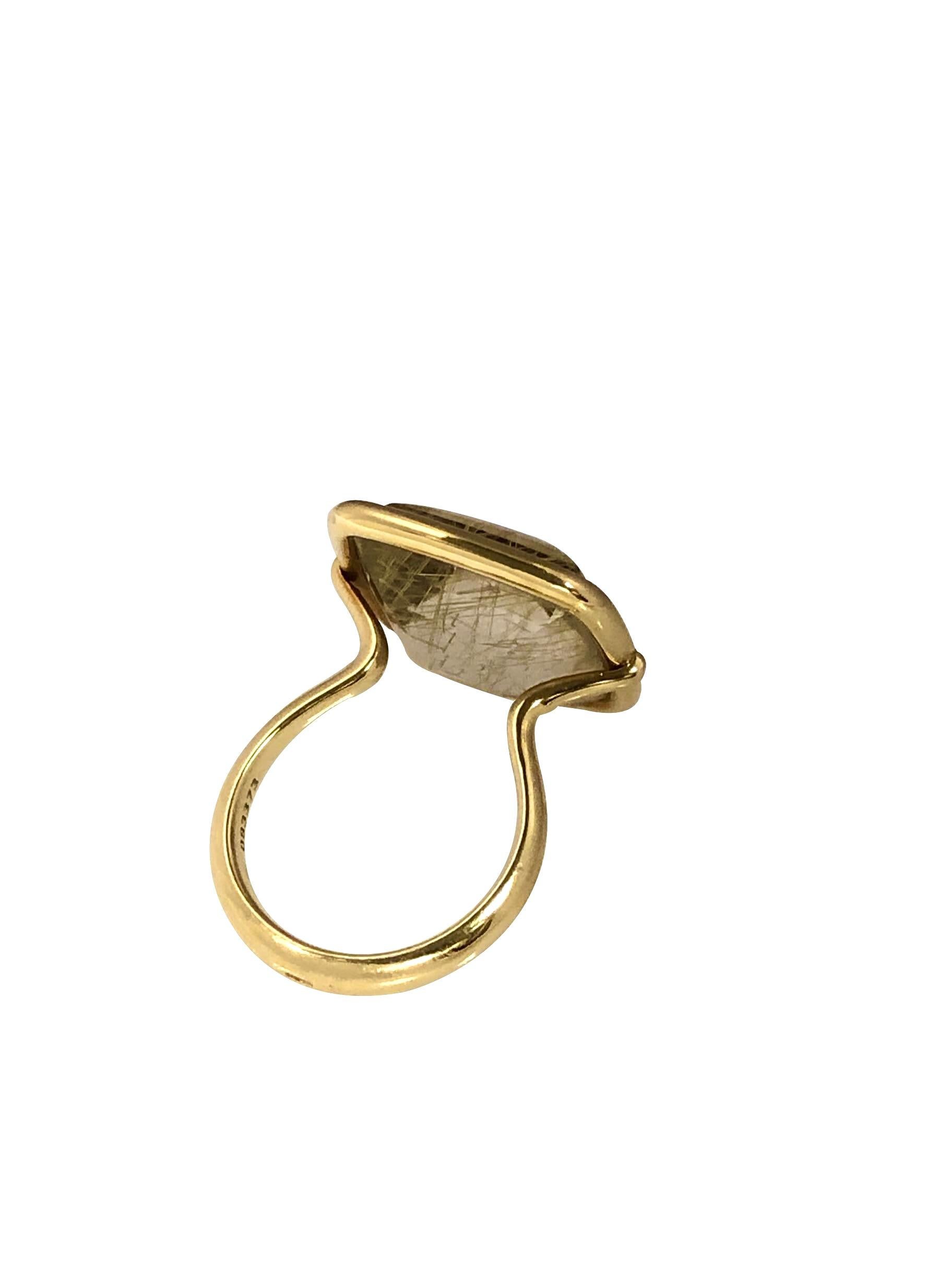 Circa 2010 Hermes 18K Yellow Gold Ring, set with a Cushion Sugar Loaf Domed Rutilated Quartz measuring 15 X 15 M.M. approximately 20 Carats, the top of the ring measures 3/4 X 3/4 inch and is uniquely attached to the shank so it can swivel back and