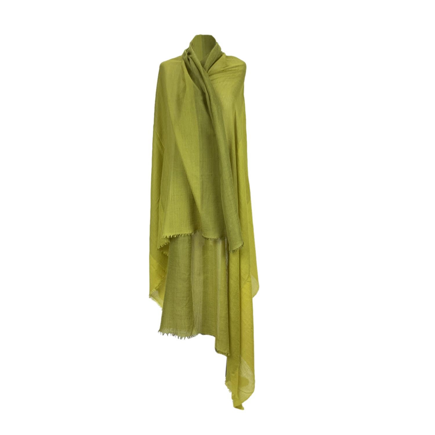 Rare cashmere and silk scarf by Hermes. Yellow and Green colors. Big H pattern in the center. Composition; 50% Cashmere, 50% Silk. Fringed hem. Approx. measurements: 50 x 90 inches - 127 x 229. Handwoven in Nepal. 'HERMES - Paris' and composition