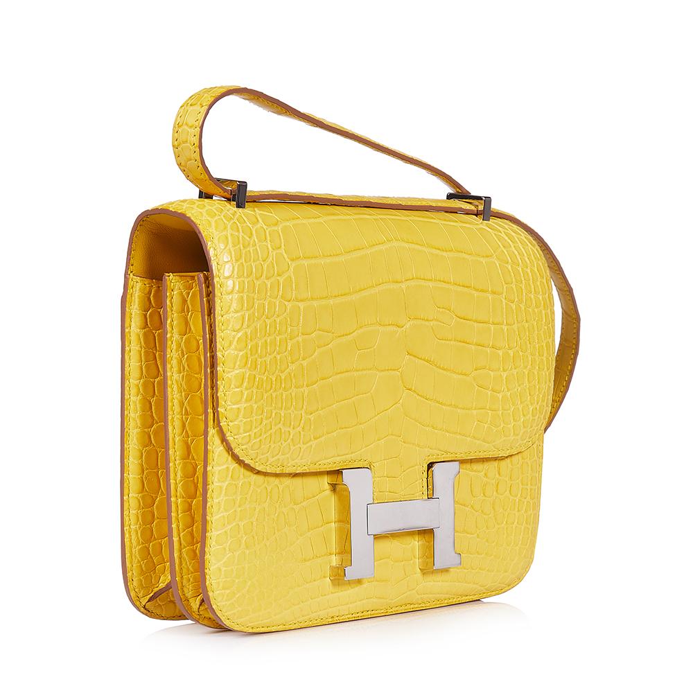 This extremely rare, Hermès Constance bag comes in a unique and extremely sought after Yellow Mimosa colour. The interior features one spacious interior compartment, containing one wide open slip pocket and one wide pocket with a zipped fastening.