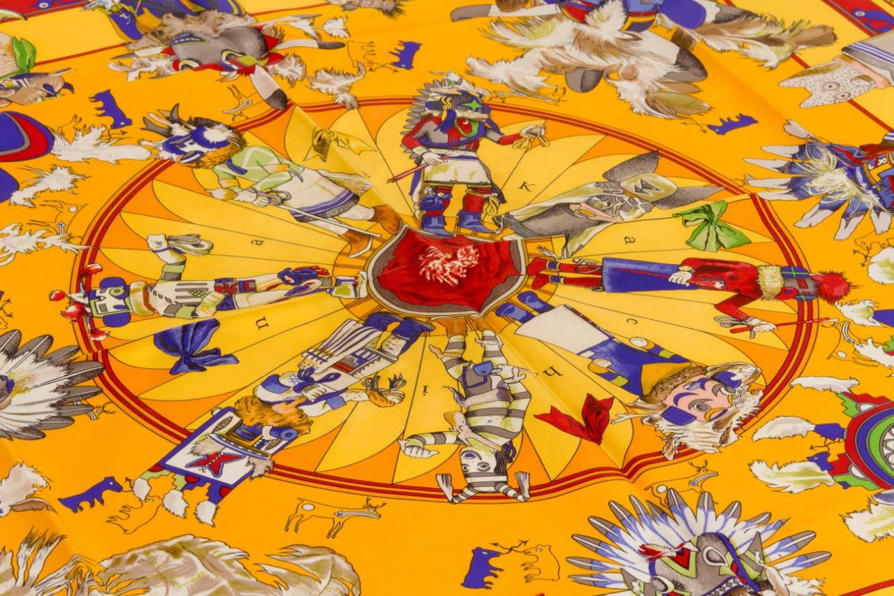 Hermès collectible yellow silk twill Kachinas scarf designed by Kermit Oliver. Hand-rolled edges. Care tag attached. Excellent condition.