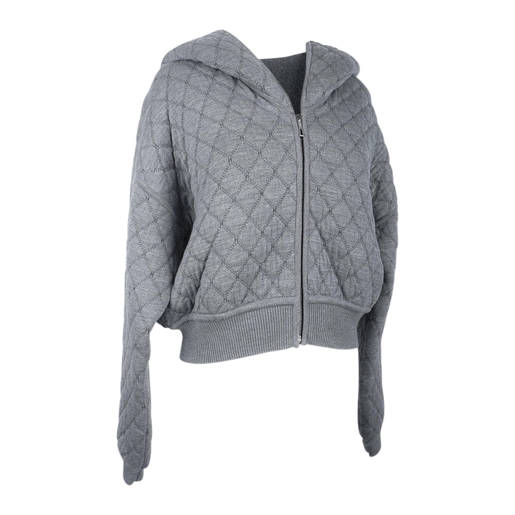 Mightychic offers an Guaranteed authentic Hermes Zip Cardigan quilted hoodie featured in grey.
Hoodie is lined in a blend of wool and camel hair.
Quilted stitiching has small H detail throughout.
Front zip with logo pull.
Drop shoulder.
Ribbed cuffs