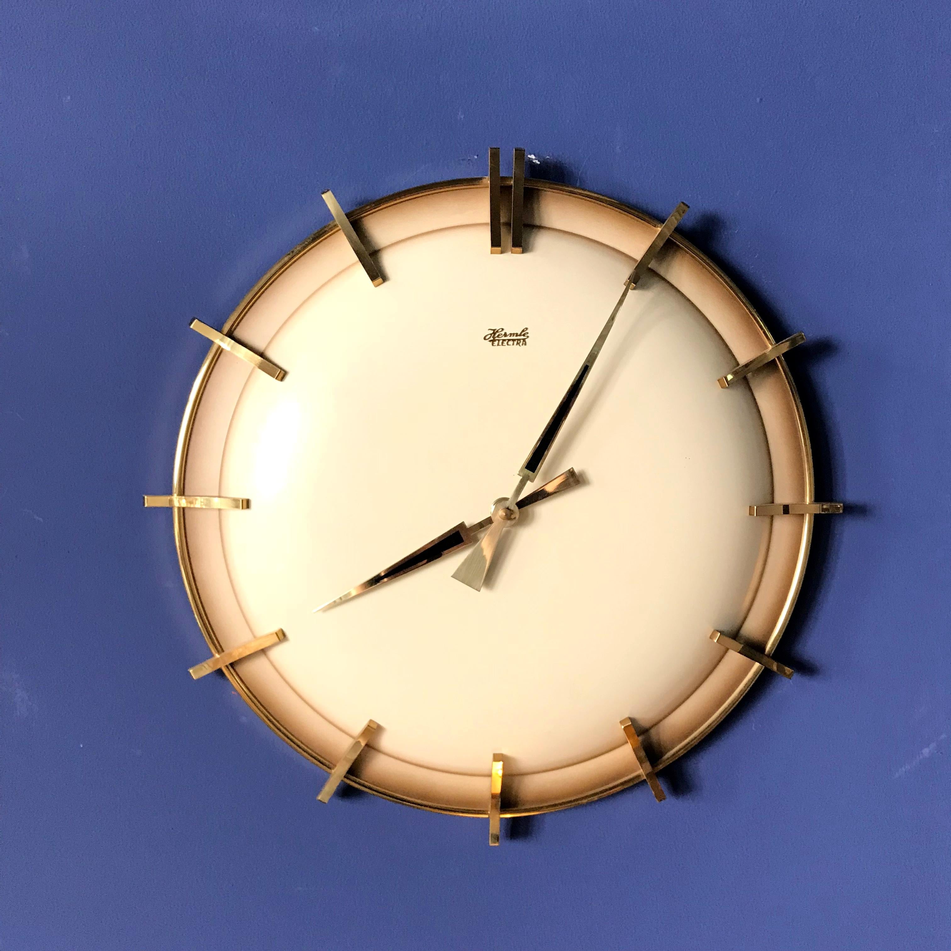 Beautiful and rare new old stock wall clock made by Hermle, Germany in 1960s. Heavy slim-line brass and metal body with the original patented Electra mechanism. New old stock in the genuine box.


 