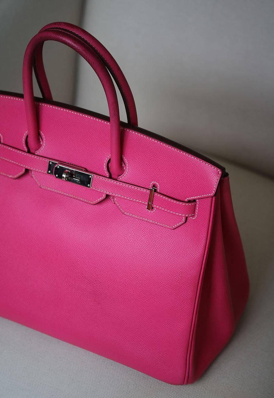 This stunning Birkin is crafted of fine epsom calfskin leather in Rose Tyrien (pink) from The Candy Collection. The bag features rolled leather top handles, a crossover flap, strap closure, palladium clasps with a palladium turn lock and a hanging
