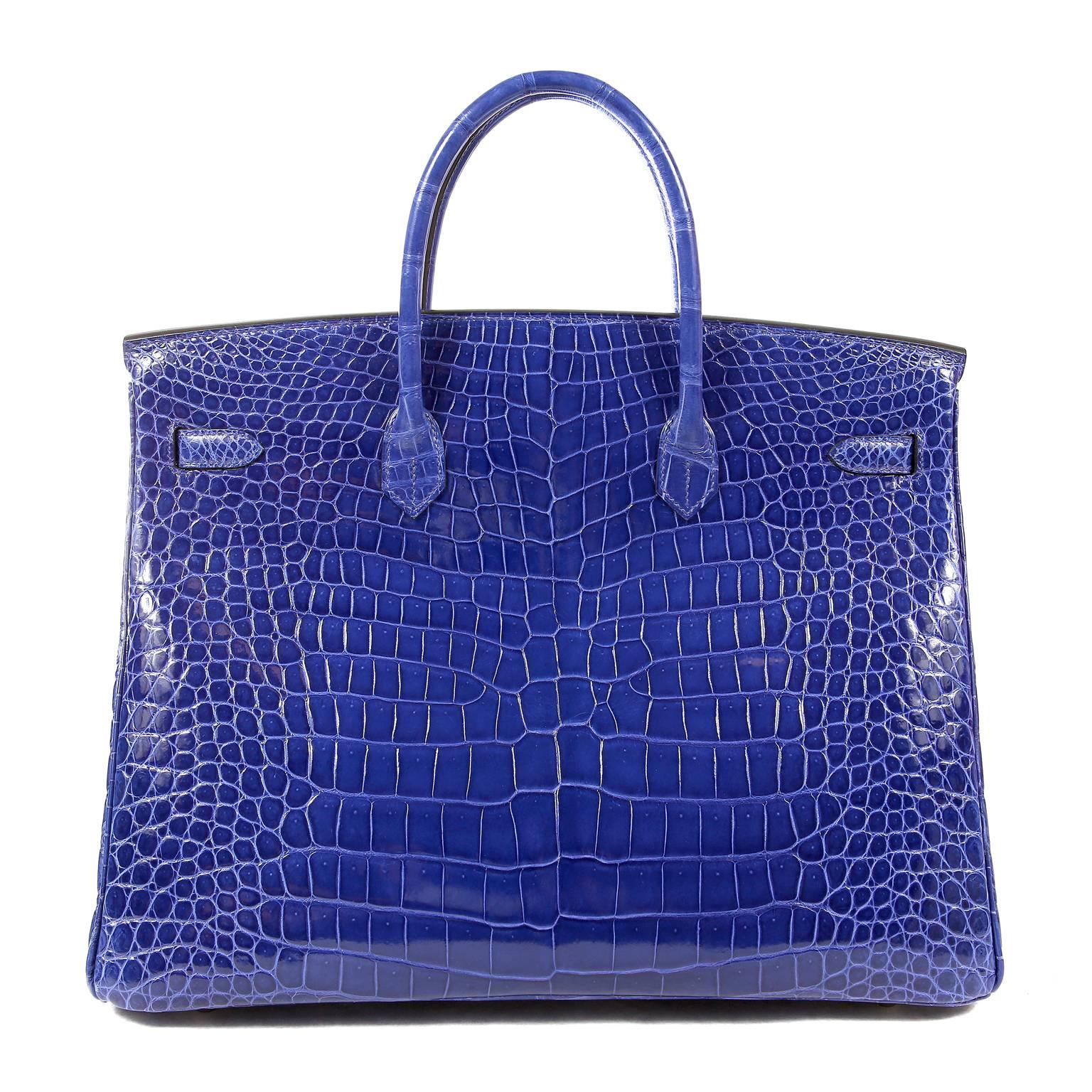 Hermès Blue Electrique Porosus Crocodile 40 cm Birkin- Pristine Condition; appears never before carried. 
Hermès bags are considered the ultimate luxury item the world over.  Hand stitched by skilled craftsmen, wait lists of a year or more are