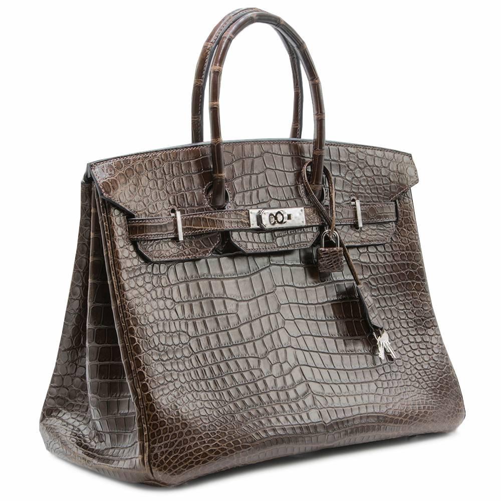 Crafted from premium crocodile leather in the deep chocolate shade and finished with palladium hardware, this Hermès Birkin exudes timeless luxury. The Porosus crocodile is said by many to be the most precious exotic skin used by Hermès, featuring a