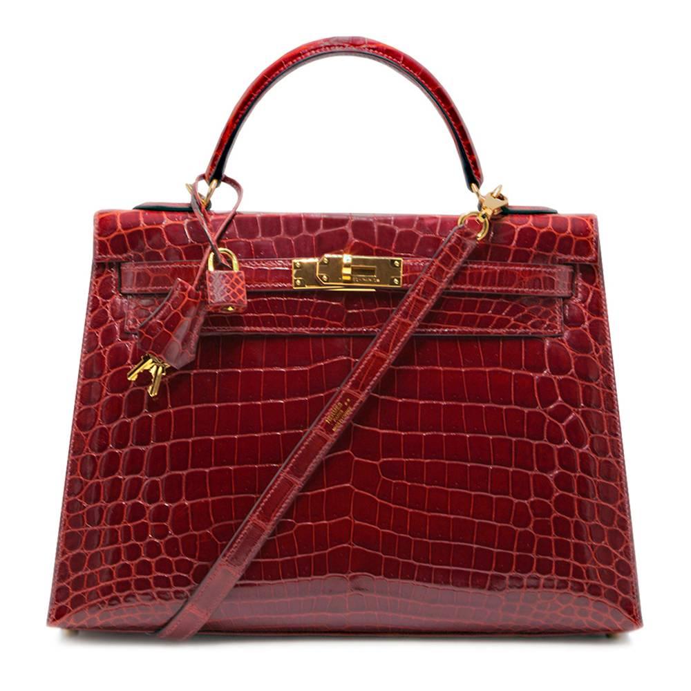 This vintage Kelly bag from Hermès is a true testament to the quality of the house's craftsmanship, exuding timeless style and elegance, perfect for any occasion with Rouge Shiny Crocodile leather and beautiful gold-tone hardware. The intricate