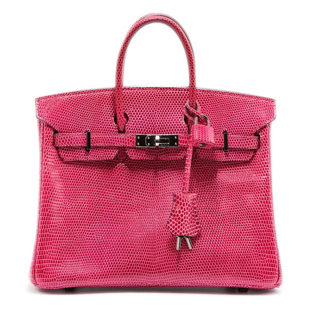 This Hermès Birkin exudes opulence, meticulously crafted from a shiny, rich and vibrant fuchsia Lizard leather, lined in a complimentary-toned pink goatskin and finished with dark silver palladium hardware. This rare bag is sure to make a statement.
