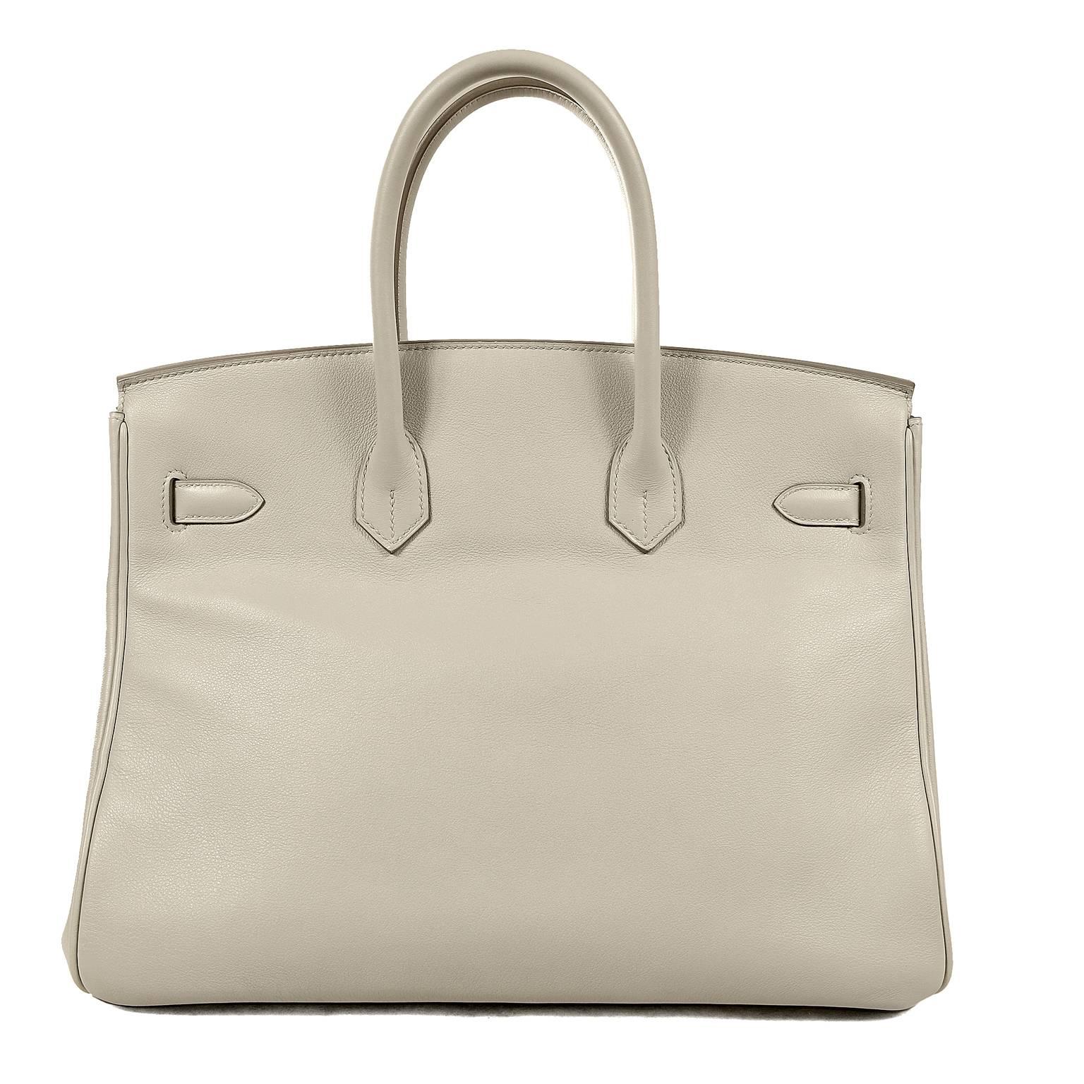 Hermès Gris Perle Swift Leather 35 cm Birkin Bag- PRISTINE condition, appearing never carried.  
Hermès bags are considered the ultimate luxury item.  Hand stitched by skilled craftsmen, wait lists of a year or more are commonplace.  Gris Perle is a