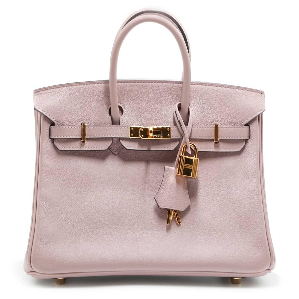 This Hermès Birkin exudes opulence, fabricated from a soft Pink Glycine. Lined in a complimentary-toned blush goatskin and finished with palladium hardware, it is a sophisticated statement perfect for styling with a summer look. Compact-sized, the