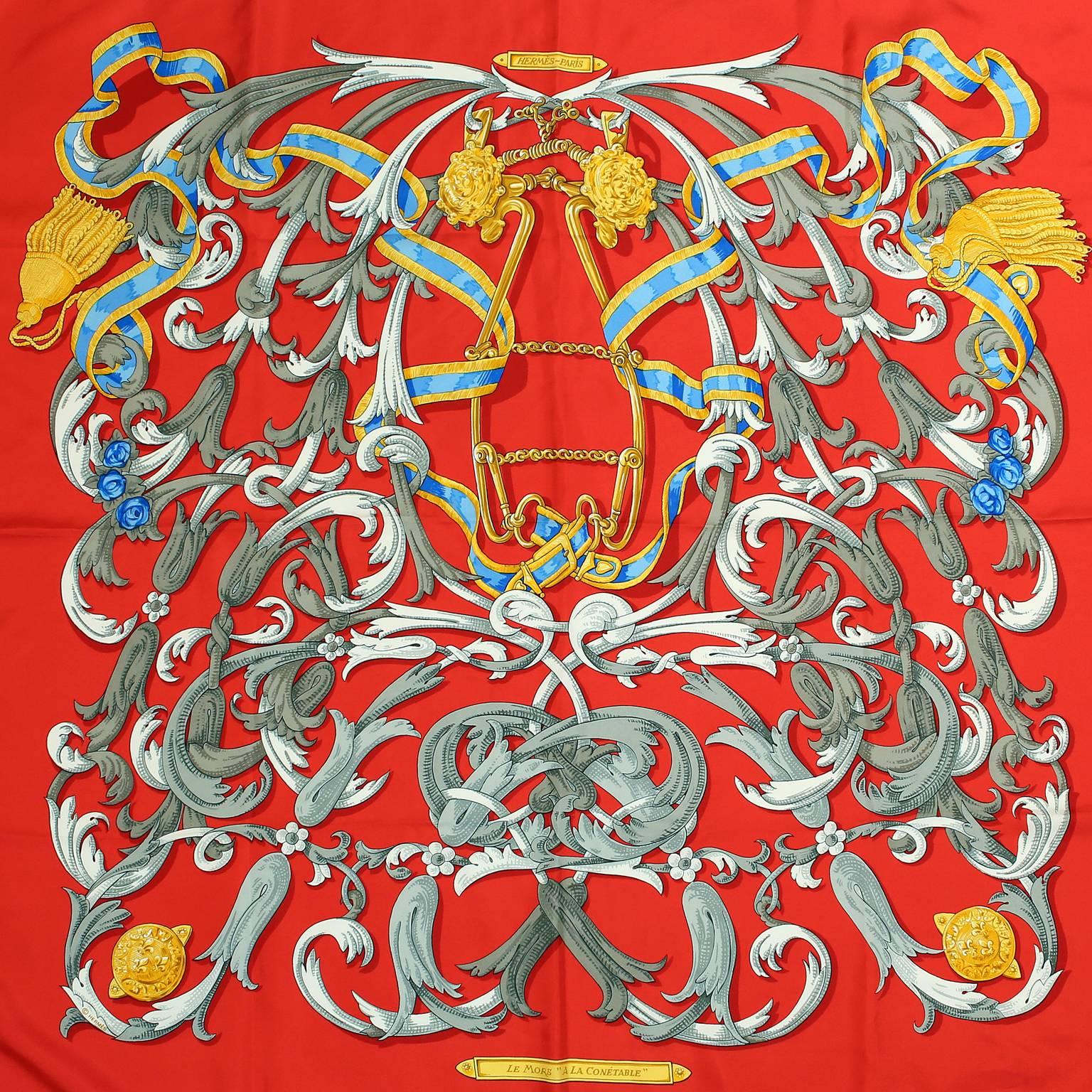 Hermès Red Le Mors a la Conetable 90 cm Silk Scarf -  Pristine
Originally designed by Henri d’Origny and released in 1970.  Equestrian themed design features a bright red background with swirling ribbons and tassels.  A gold toned halter and bit are