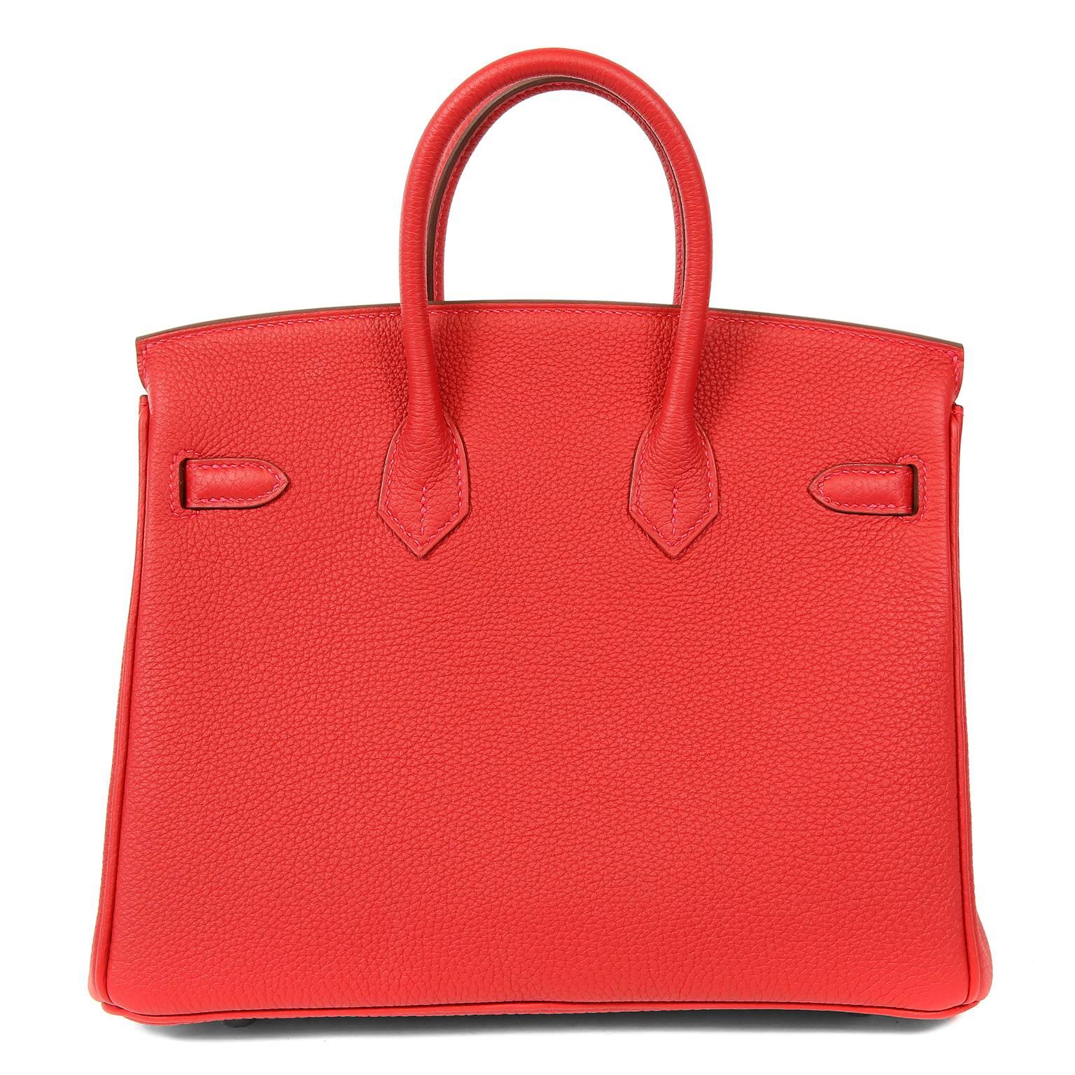 Hermès Rouge Garance Togo 25 cm Birkin Bag is in pristine unworn condition with the protective plastic intact on the hardware.  Waitlists exceeding a year are commonplace for the intensely coveted Birkin bag.  Each piece is hand crafted by skilled