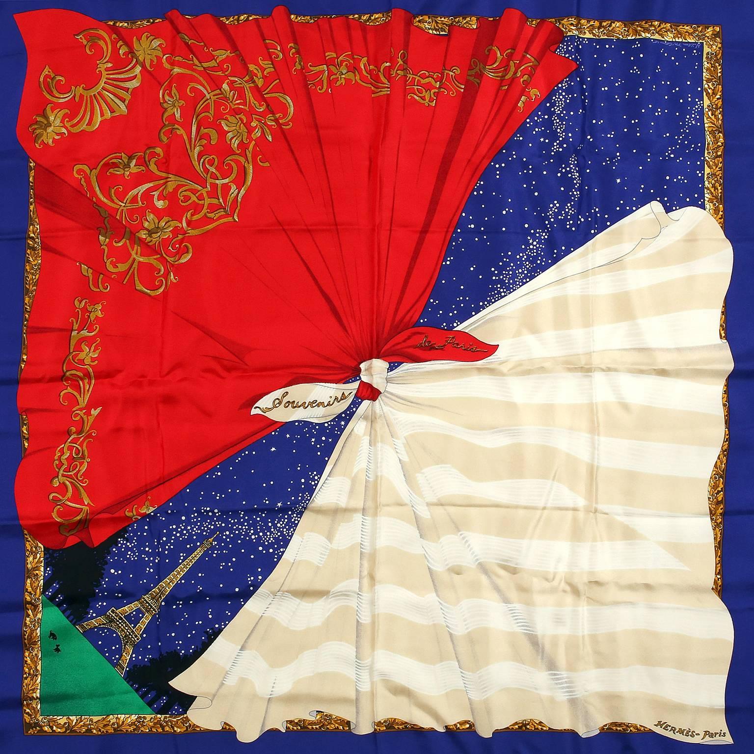 Hermès Souvenirs de Paris 90 cm Silk Scarf- PRISTINE
Designed by Hilton McConnico in the French national colors of red, white and blue. 
A blue background depicts a starry night in Paris, featuring the Eiffel Tower and two Hermès scarves tied