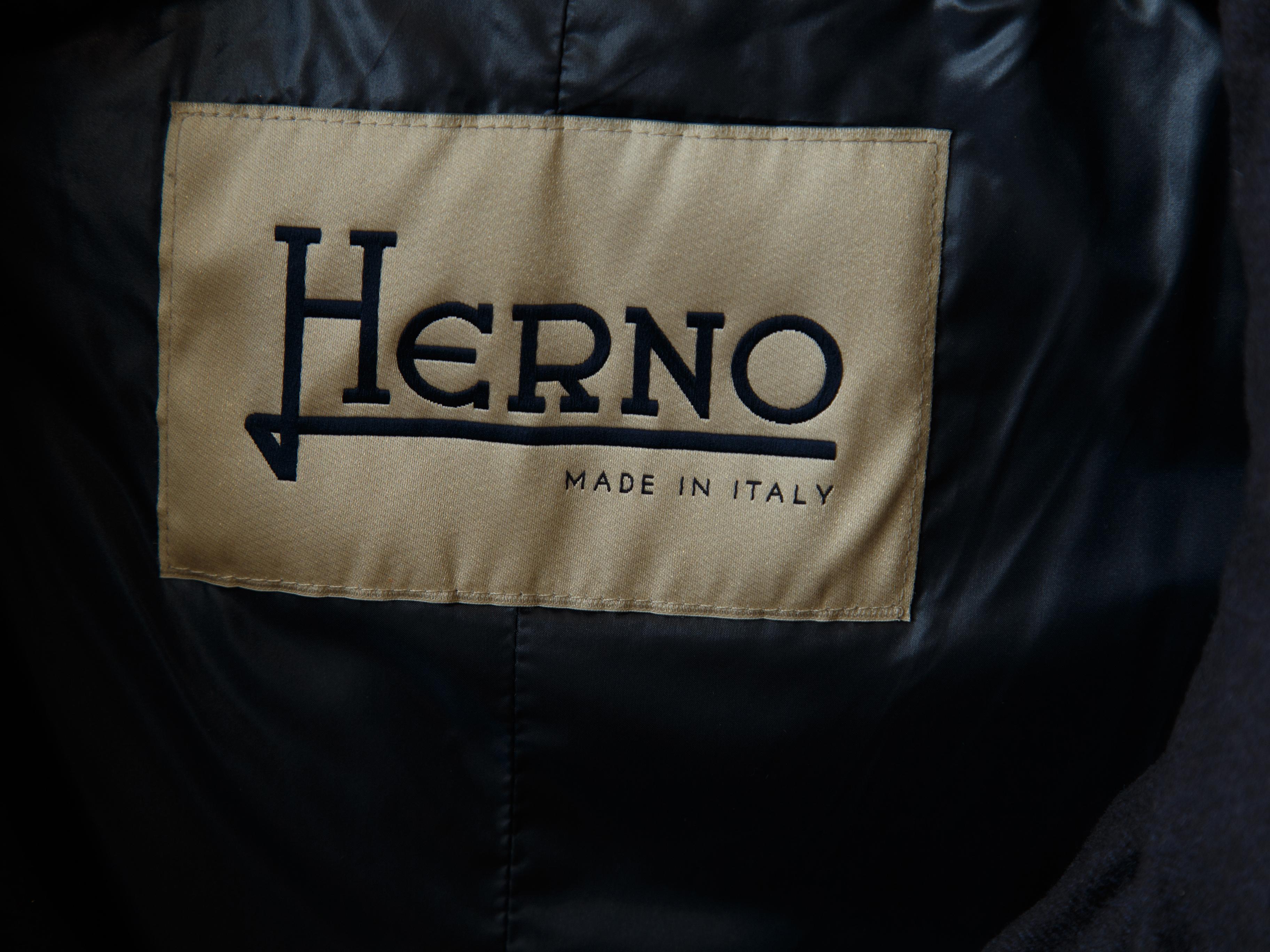 Product details:  Navy blue cashmere/silk-blend down puffer coat by Herno.  Stand collar.  Long sleeves.  Button-front closure.  On-seam slide pockets.  Goldtone hardware.  30