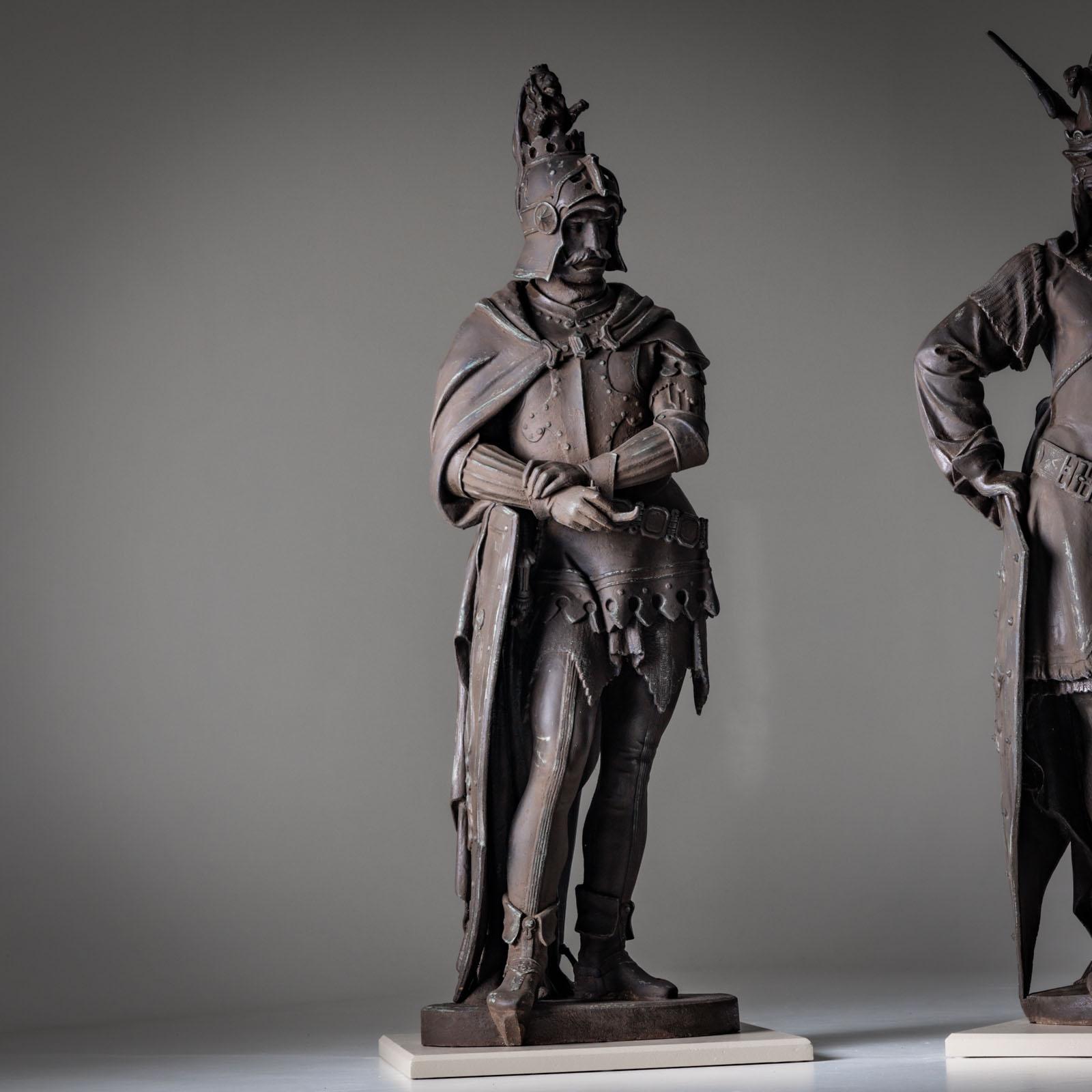 Two almost life-size cast iron statues with great depth of detail and bronze-colored patina.

Dimensions left: 153 x 60 x 40 cm
Dimensions right: 154 x 50 x 40 cm

The statues most likely depict central heroes of the Nibelung saga. The statue on the
