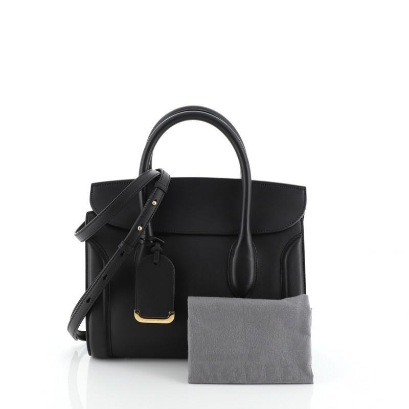 This Alexander McQueen Heroine Convertible Tote Leather 30, crafted from black leather, features dual rolled leather handles and gold-tone hardware. Its flap opens to a neutral microfiber interior with side zip and slip pockets. 

Estimated Retail