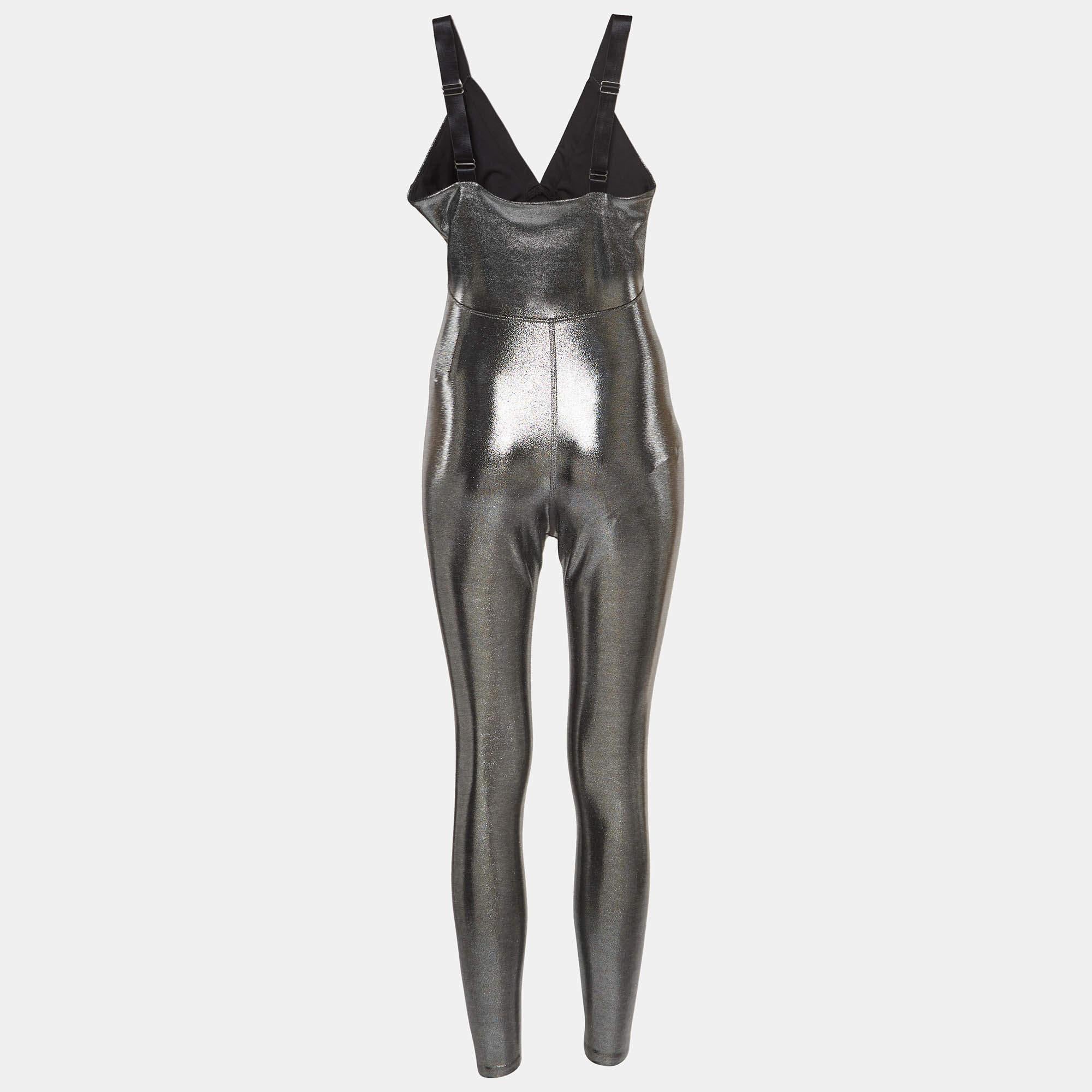 The Heroine jumpsuit is a stunning one-piece statement ensemble, blending fashion and function. Crafted with eye-catching metallic silver lamé fabric, it features a sleek design, form-fitting silhouette, and flattering v-neck, making it a bold and