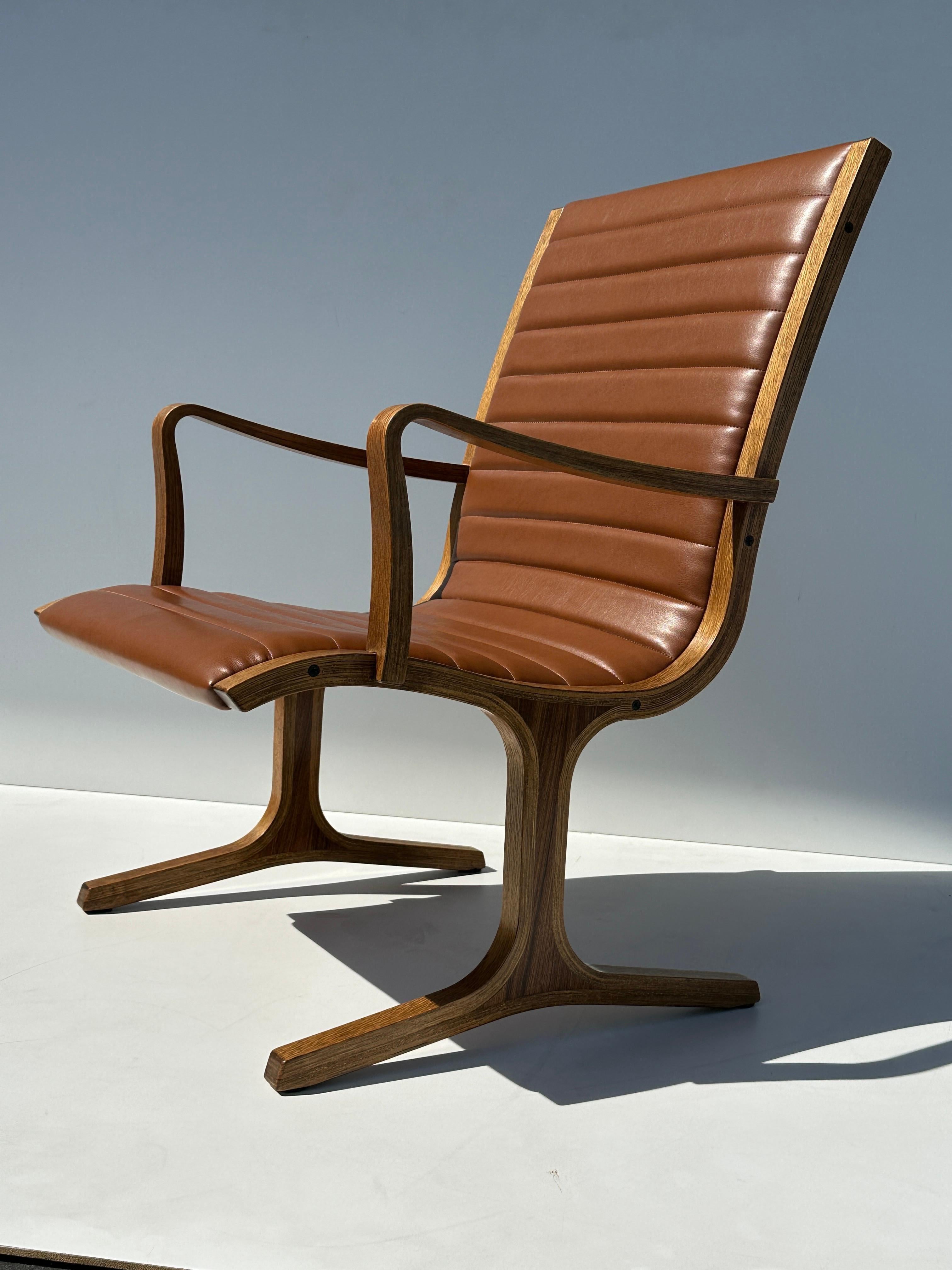 “Heron” chair designed by Mitsumasa Sugasawa for Tendo Mokko Japan. Made of bent laminated oak with rosewood inserts on legs and newly reupholstered in soft vinyl. Arm height is 22” Beautiful example of mid century modern Japanese furniture.