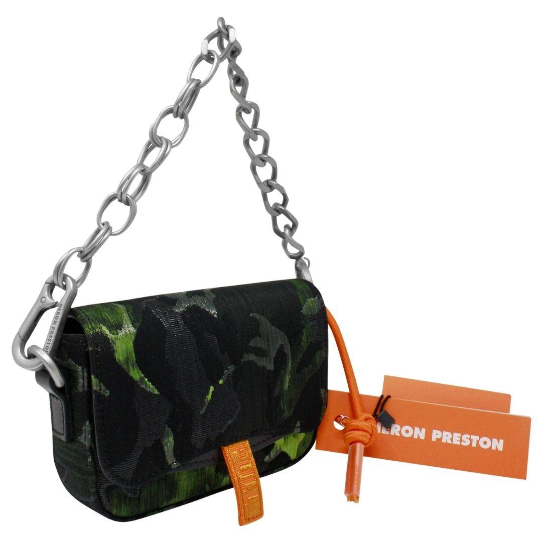 From the spring/summer collection, this edgy camo mini piece is crafted of jacquard fabric, featuring a removable chain handle, a magnetic closure with PULL print tape. Belt loops and fabric logo patch on the back, logo embossed on the base, fabric