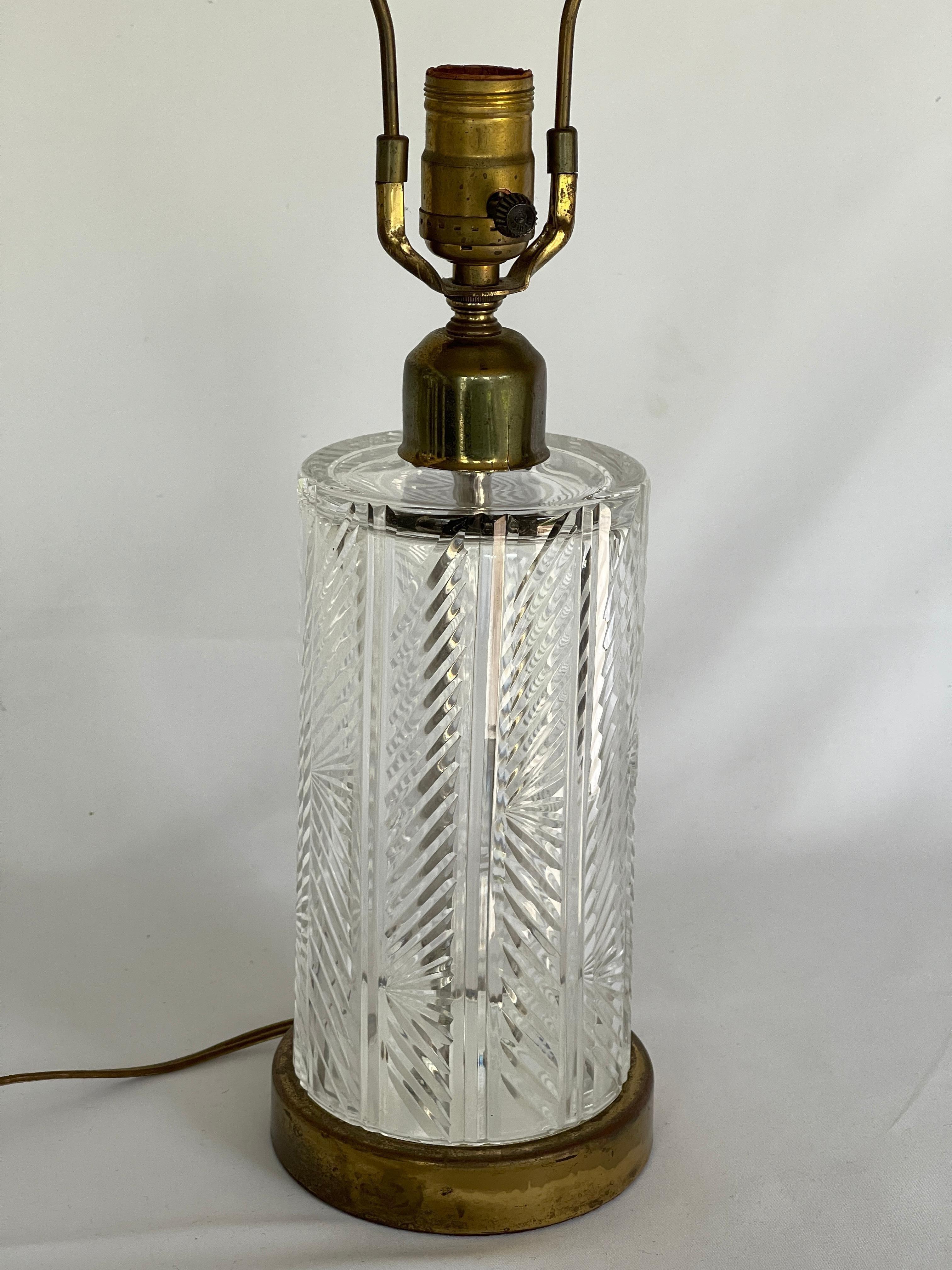 Herringbone pattern cut crystal column lamp with circular brass base and faceted lucite finial. Measures 22.3