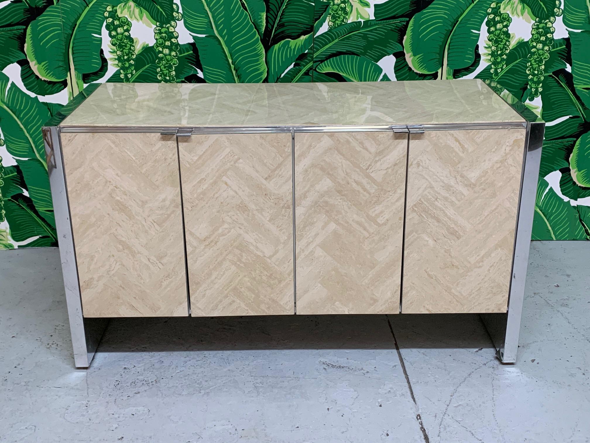 Midcentury credenza features stone inlay in a herringbone pattern and chrome accents. In the style of Ello or Milo Baughman. Good condition with minor imperfections consistent with age.