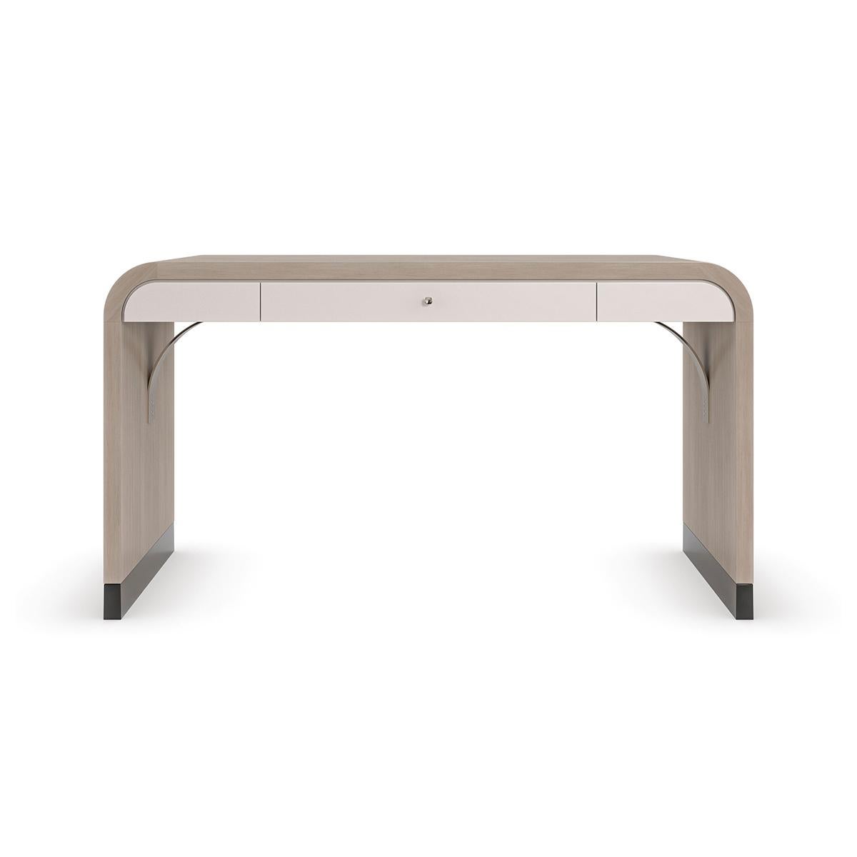 Herringbone Waterfall Desk, create a serene space for work and moments of reflection with this parsons style desk, engaging the senses with its fluid form and gently rounded edges.

A pearlescent Moonstone finish gives light to the exquisite