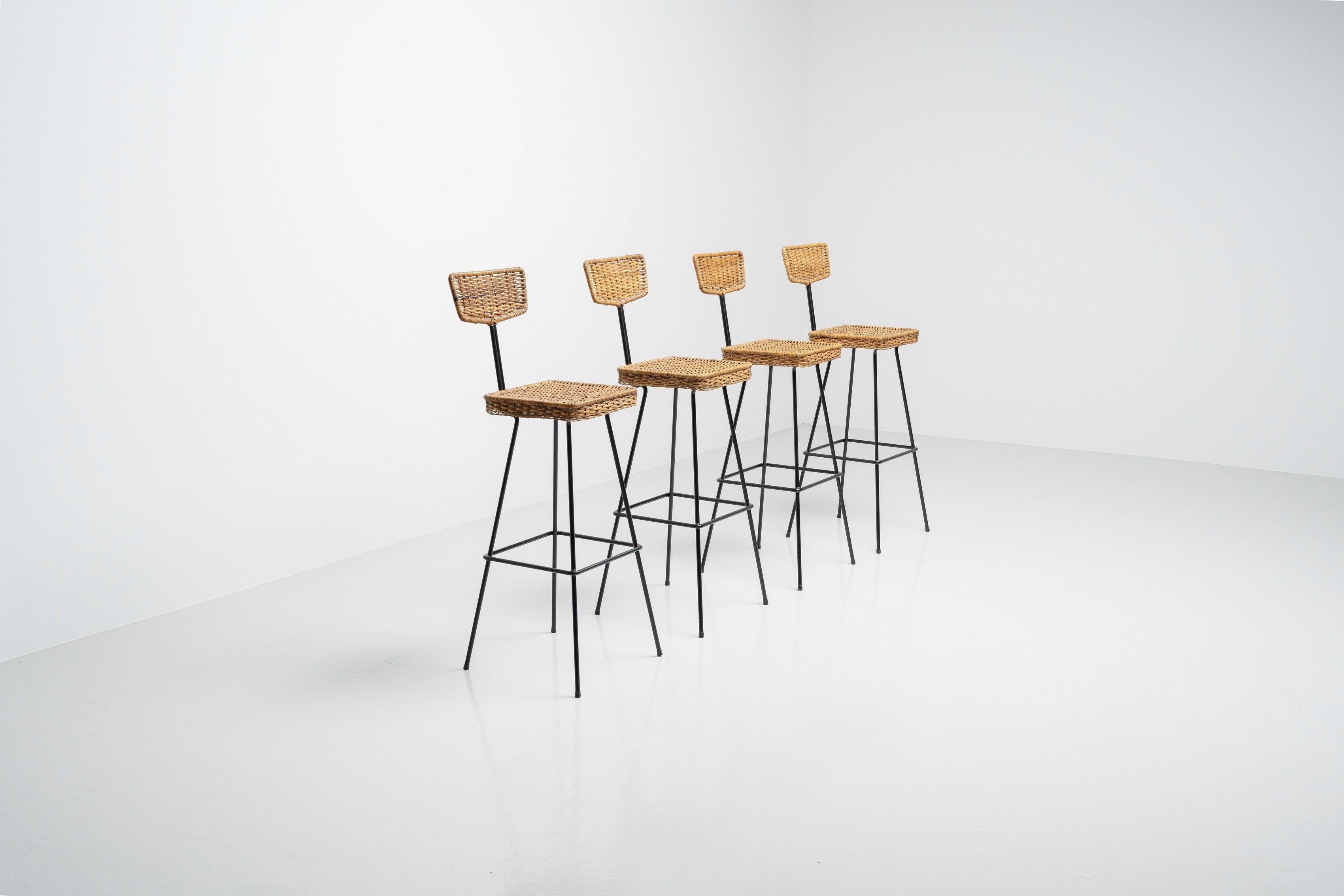 Set of four bar stools designed by Herta Maria Witzemann  and manufactured by Erwin Behr in 1950. The work of Witzemann typically consists out of light and vibrant structures, which have a feeling of lightness to it and woven cane was often used as