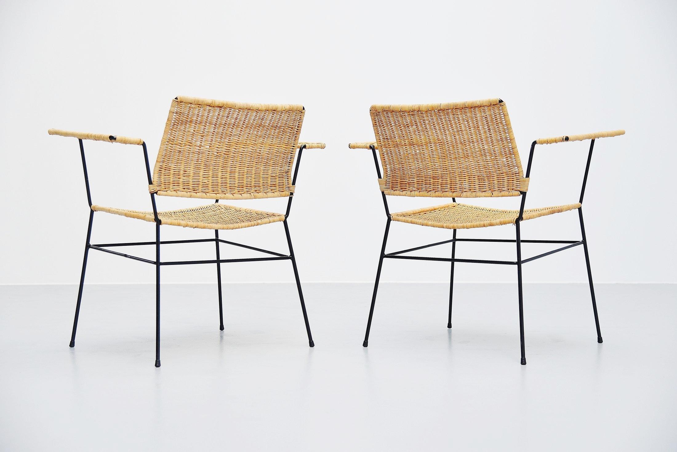 Fantastic pair of armchairs designed by Herta Maria Witzemann and manufactured by Erwin Behr, Germany 1954. The chairs have solid metal frames and hand woven cane seats and armrests. Super shaped pair of chairs and comfortable seating too. The