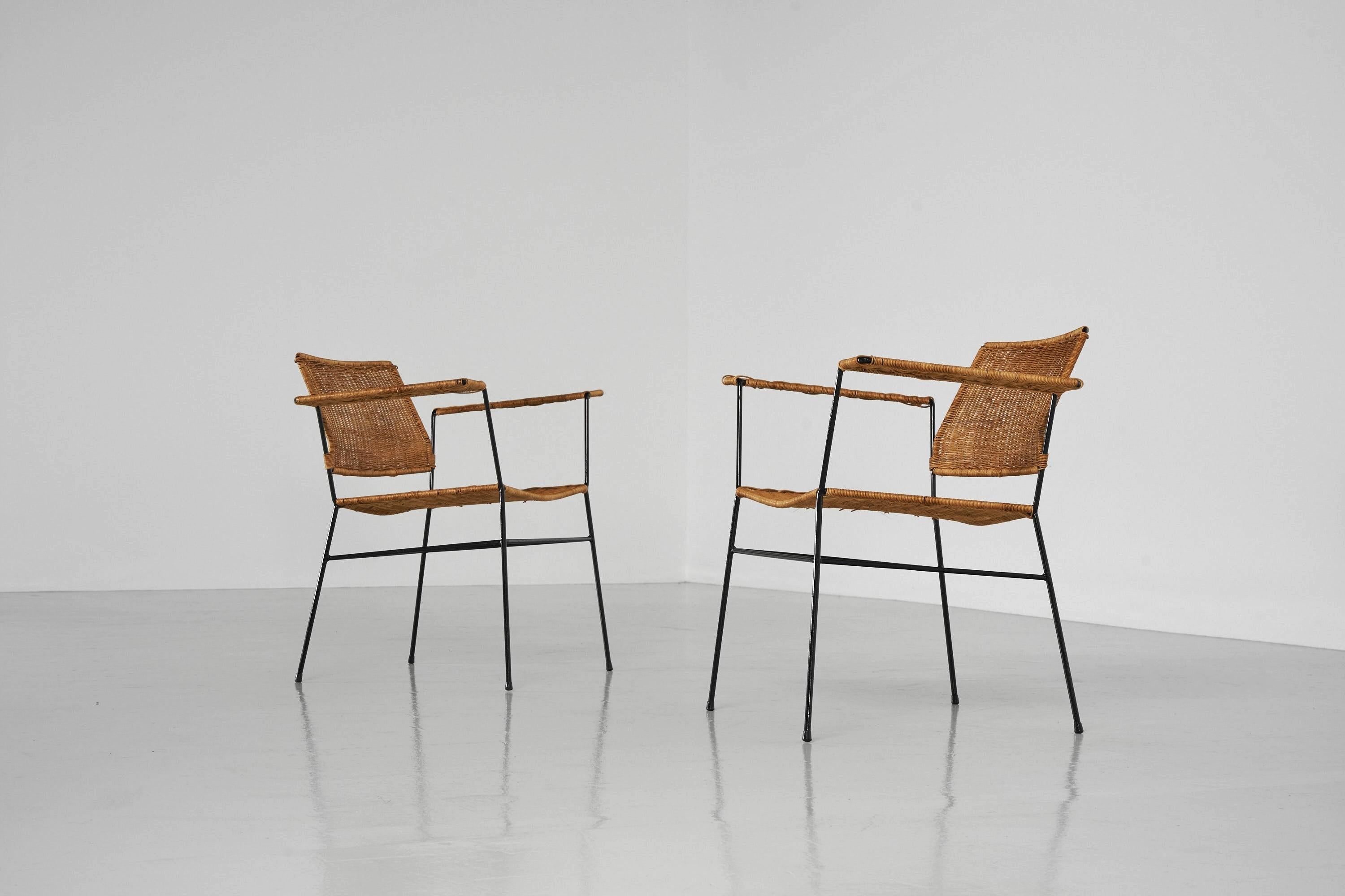 Fantastic pair of armchairs designed by Herta Maria Witzemann and manufactured by Wilde & Spieth, Germany 1954. The chairs have solid metal frames and hand-woven cane seats and armrests which is in fantastic condition with a great patina to it. The