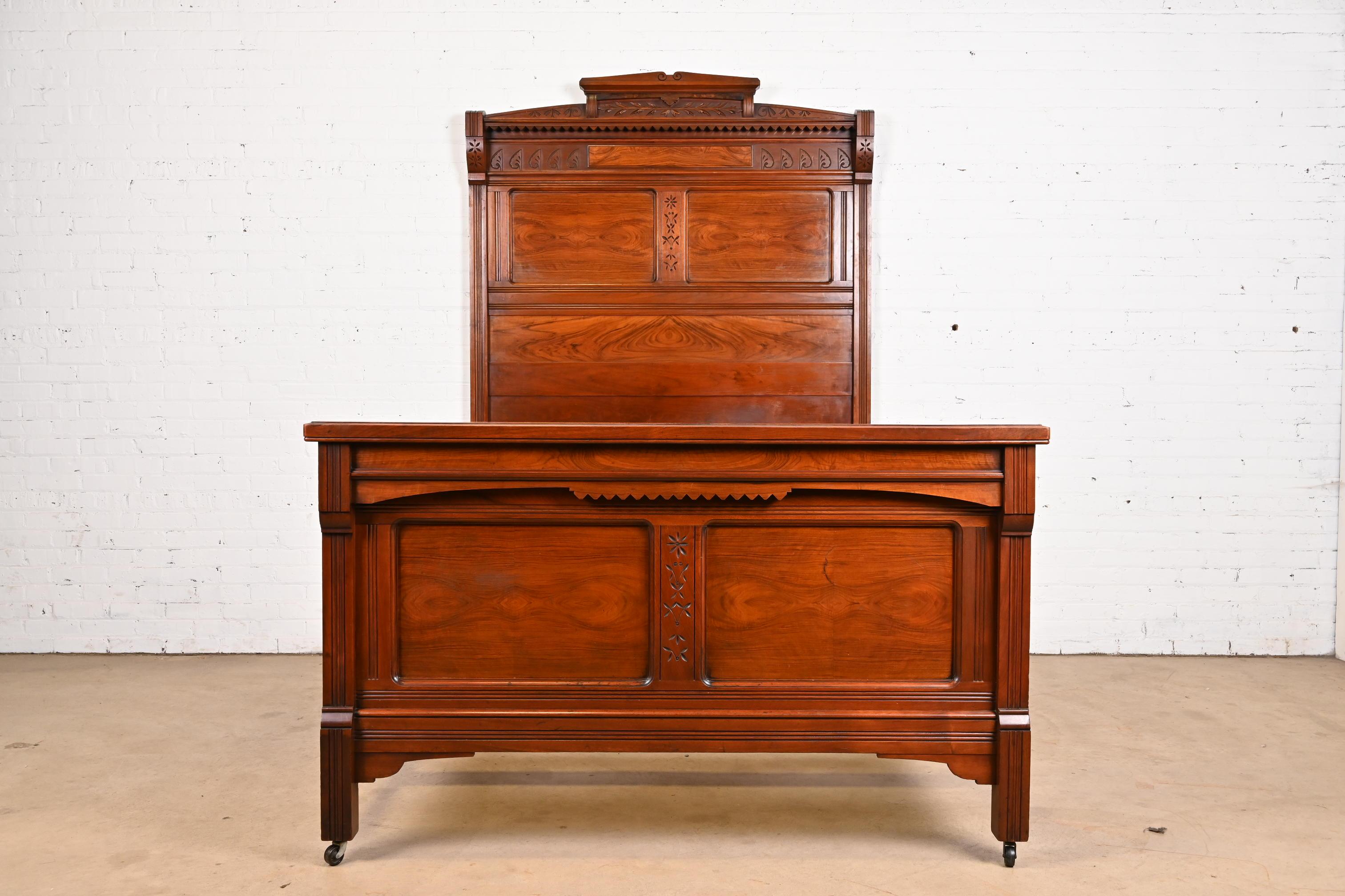 A gorgeous monumental antique Eastlake Victorian full size bed frame

In the manner of Herter Brothers

USA, Circa 1880s

Carved walnut, with burled walnut panels.

Measures: 60.75