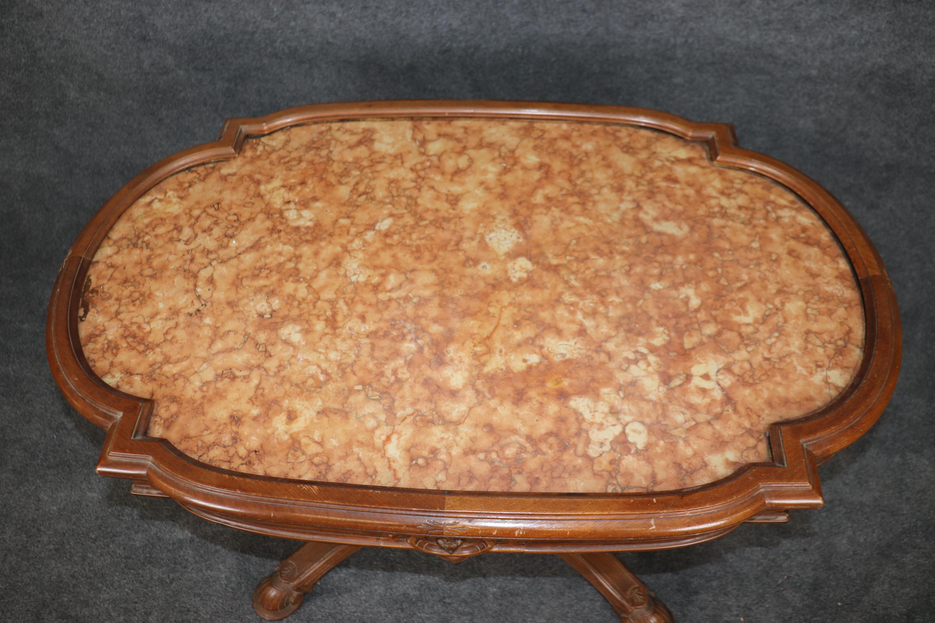This is a beautiful carved walnut and marble center table that we are attributing to Herter Brothers, one of the USA's most famous Victorian cabinetmakers. The table is in good original condition and features a gorgeous inset slab of marble and