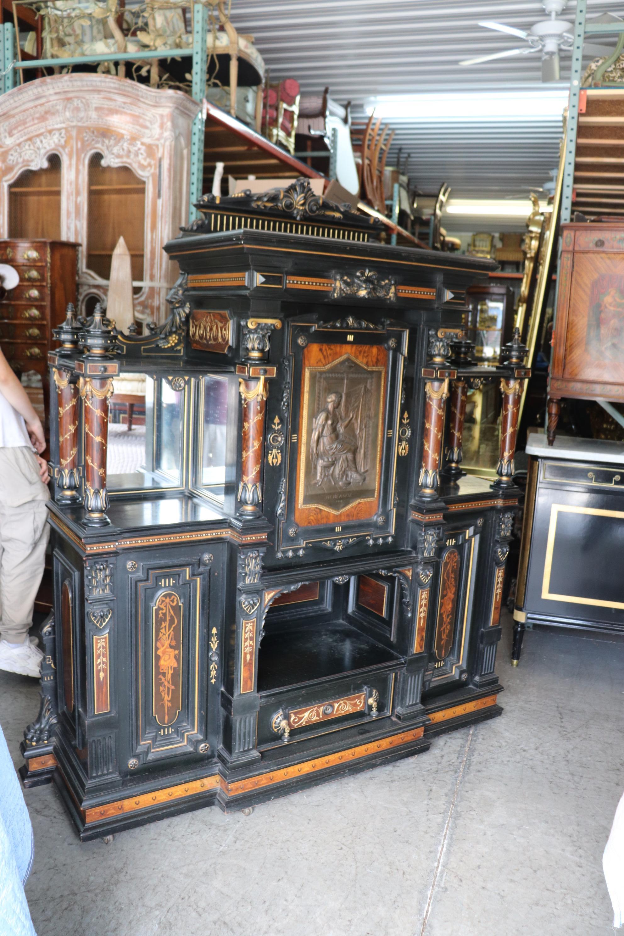 This is a breathtaking and never seen before Renaissance revival aesthetic movement rosewood and bronze china cabinet or cupboard that has every attribute Herter brothers of New York would have used: and in one piece of furniture. The piece is made