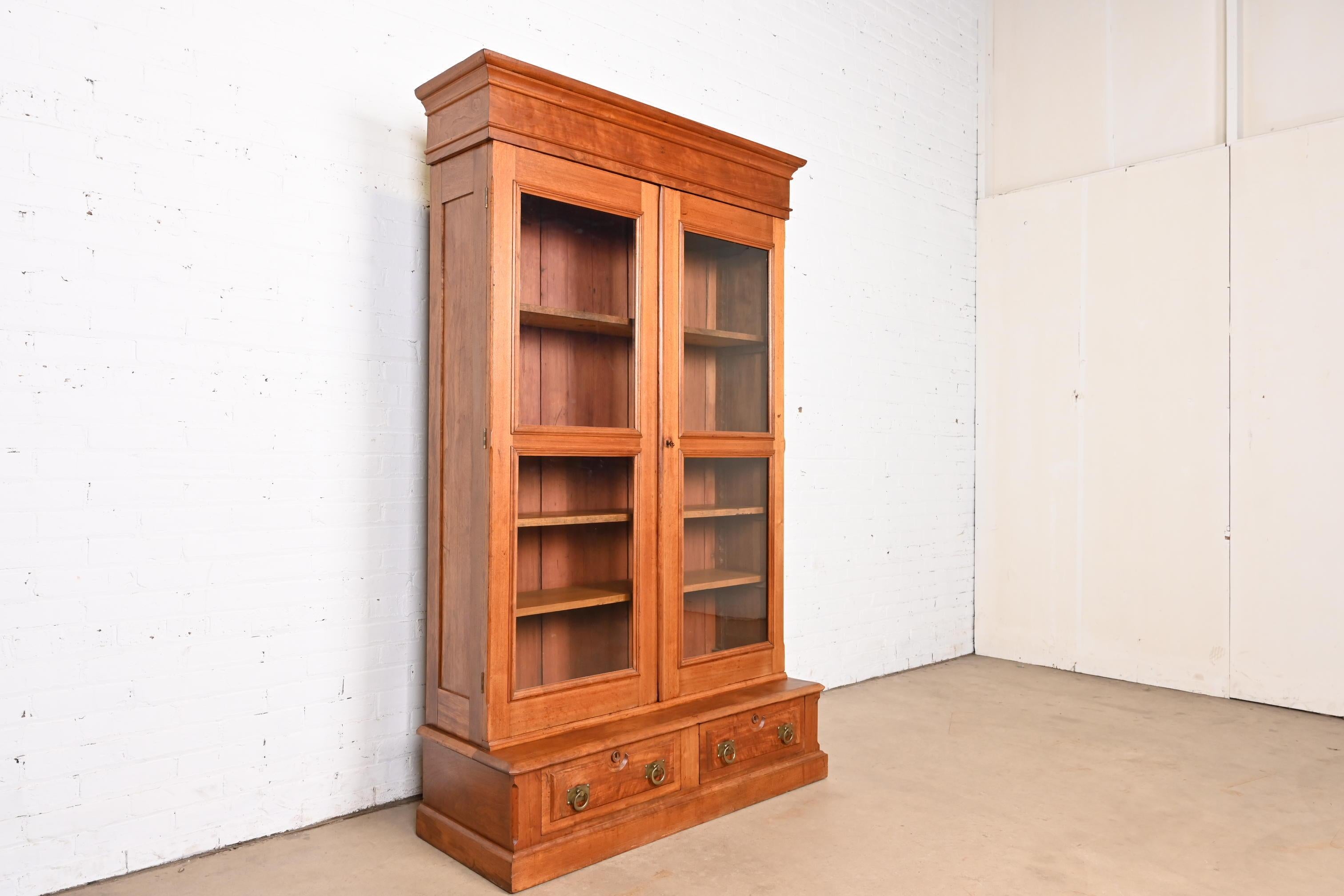 A beautiful antique Eastlake Victorian bookcase cabinet

In the manner of Herter Brothers

USA, Circa 1880s

Carved walnut, with glass front doors, and original brass hardware. Cabinet locks, and key is included.

Measures: 47.38