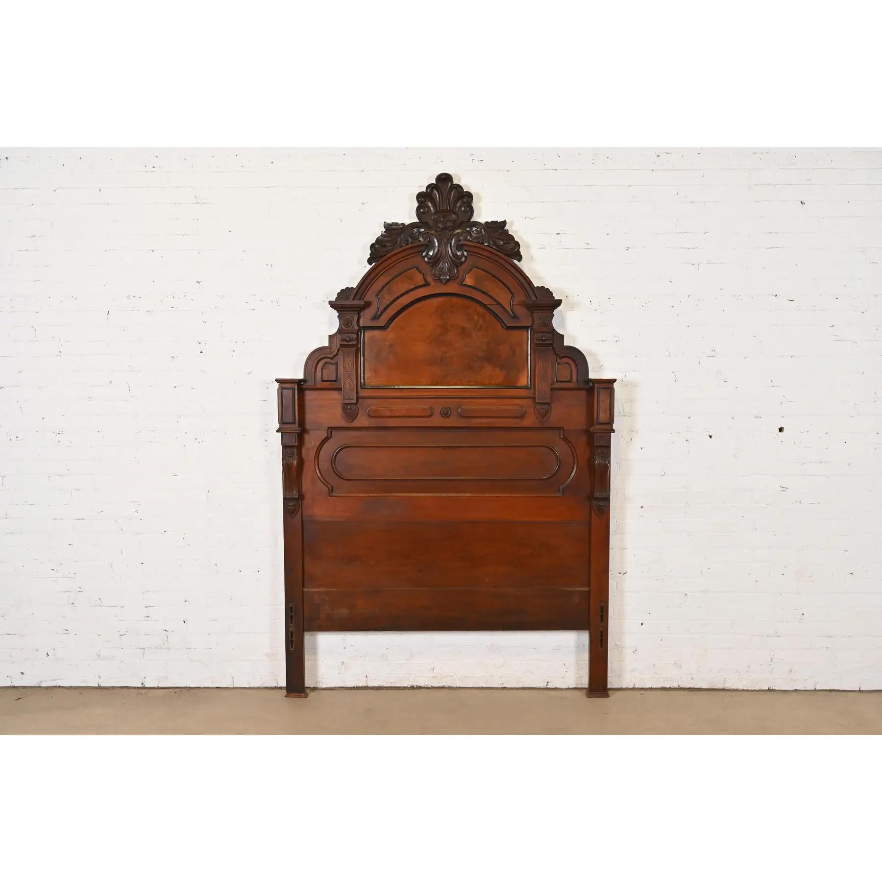 An outstanding antique Eastlake Victorian monumental full size headboard

In the manner of Herter Brothers

USA, Circa 1880s

Carved solid walnut, with burled walnut panels.

Measures: 59.75