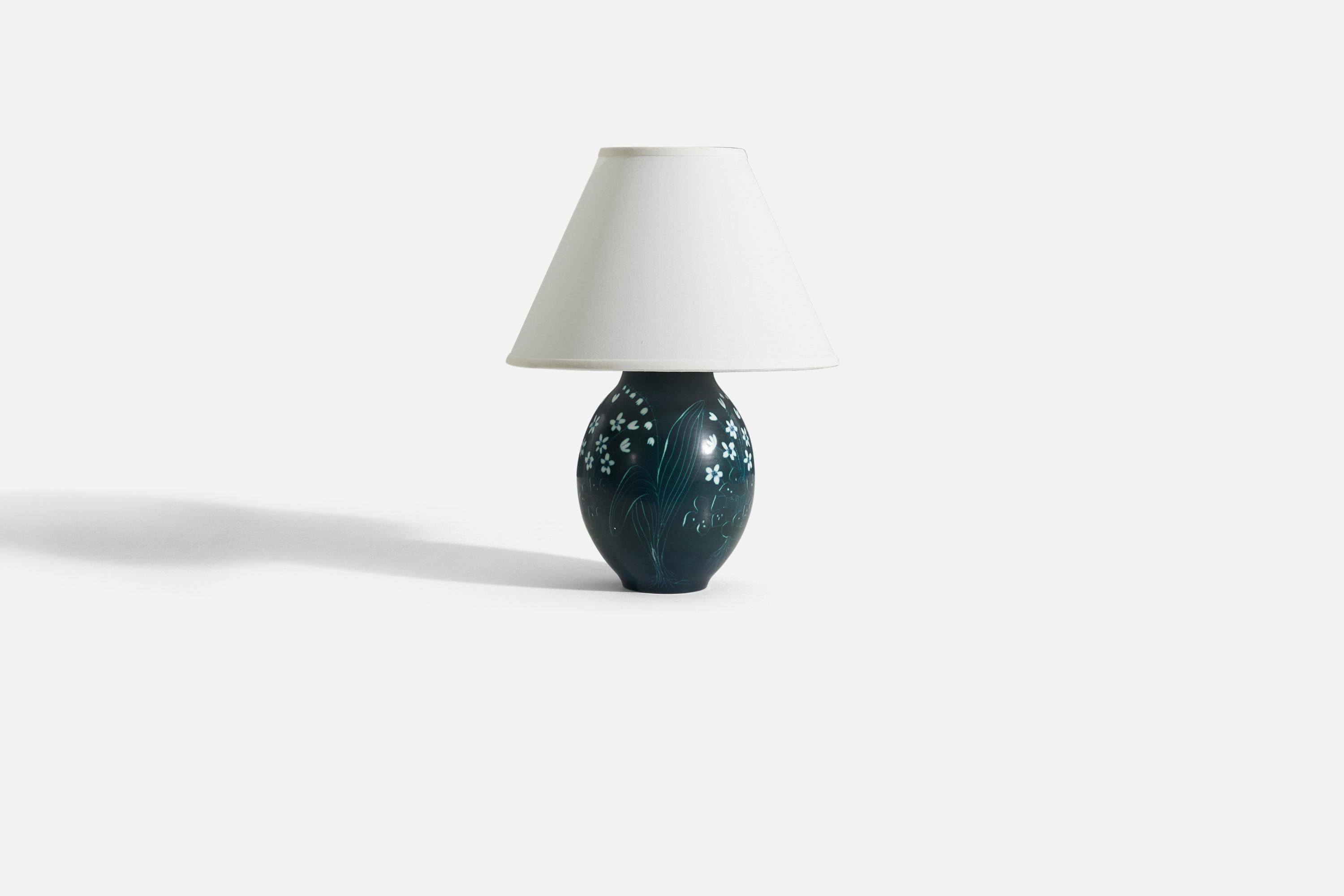 A table lamp designed by Hertha Bengtsson, (Swedish, 1914-1997) and produced by Rörstrand, Sweden, c. 1950s. In blue and white-glazed stoneware with floral motifs.

Measurements listed are of the lamp itself. Sold without lampshade.
For