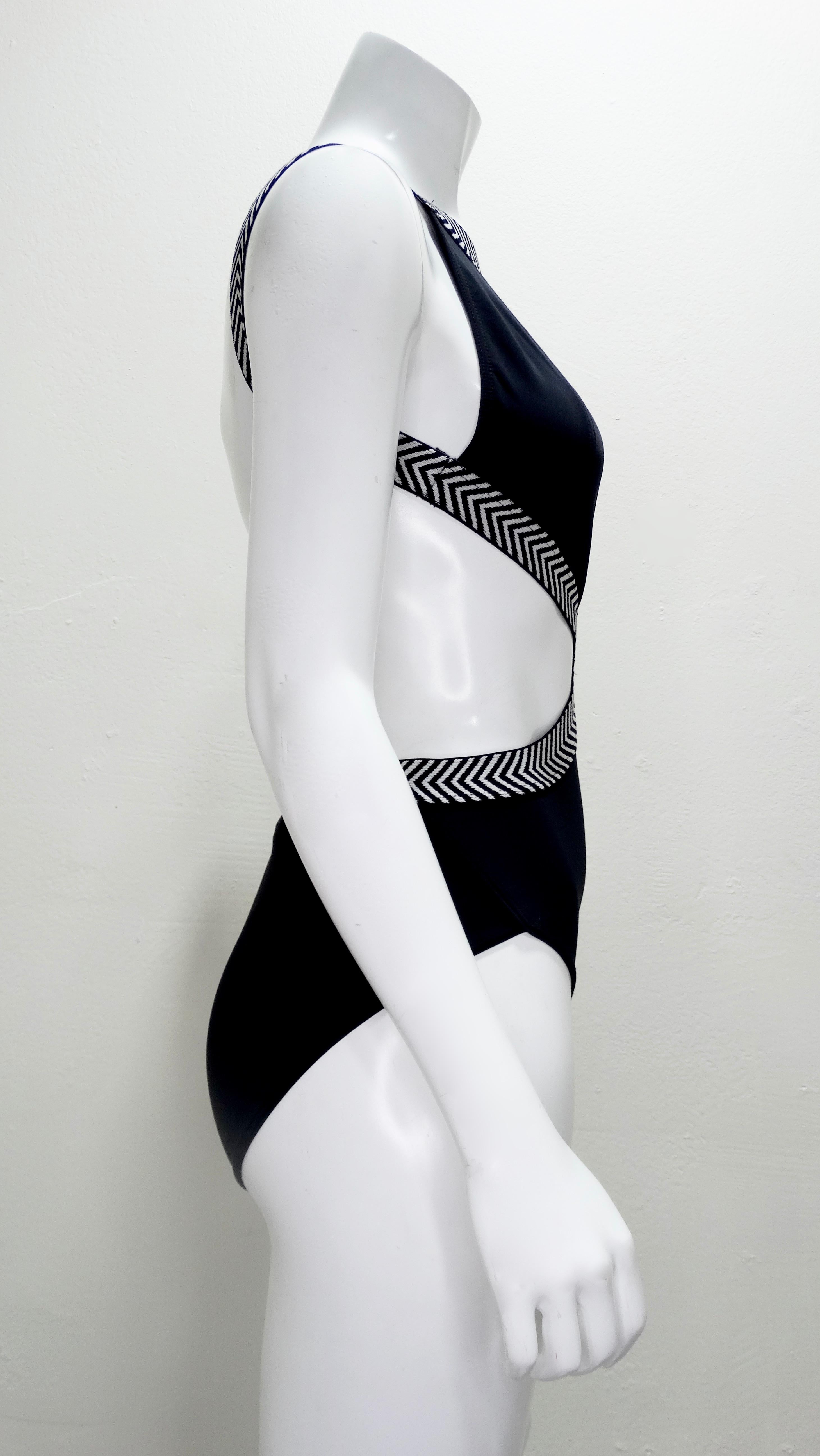 Be beach ready at all times with this adorable Herve Leger one piece swimsuit! Circa 1990s, this swimsuit features a black and white elastic trim with cut outs and an open back. Perfect for the pool or the beach, this swimsuit will pair perfectly