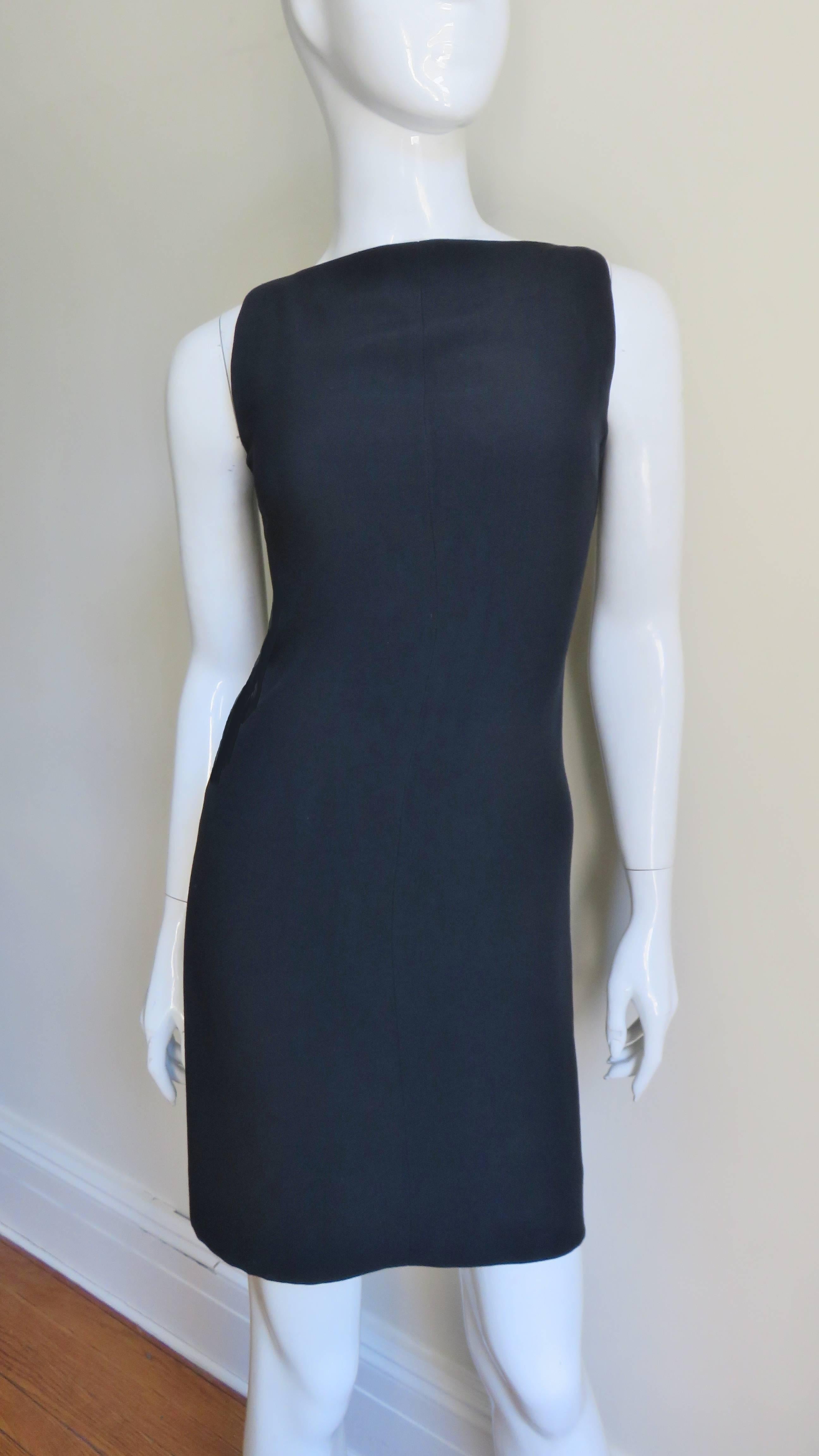 A great little black dress from Herve Leger.  It has a front bateau cut neckline turning into a low cut back.  The dress wraps at the back and closes with hooks, eyes and snaps.  
Fits sizes Extra Small, Small, Medium.

Bust  34